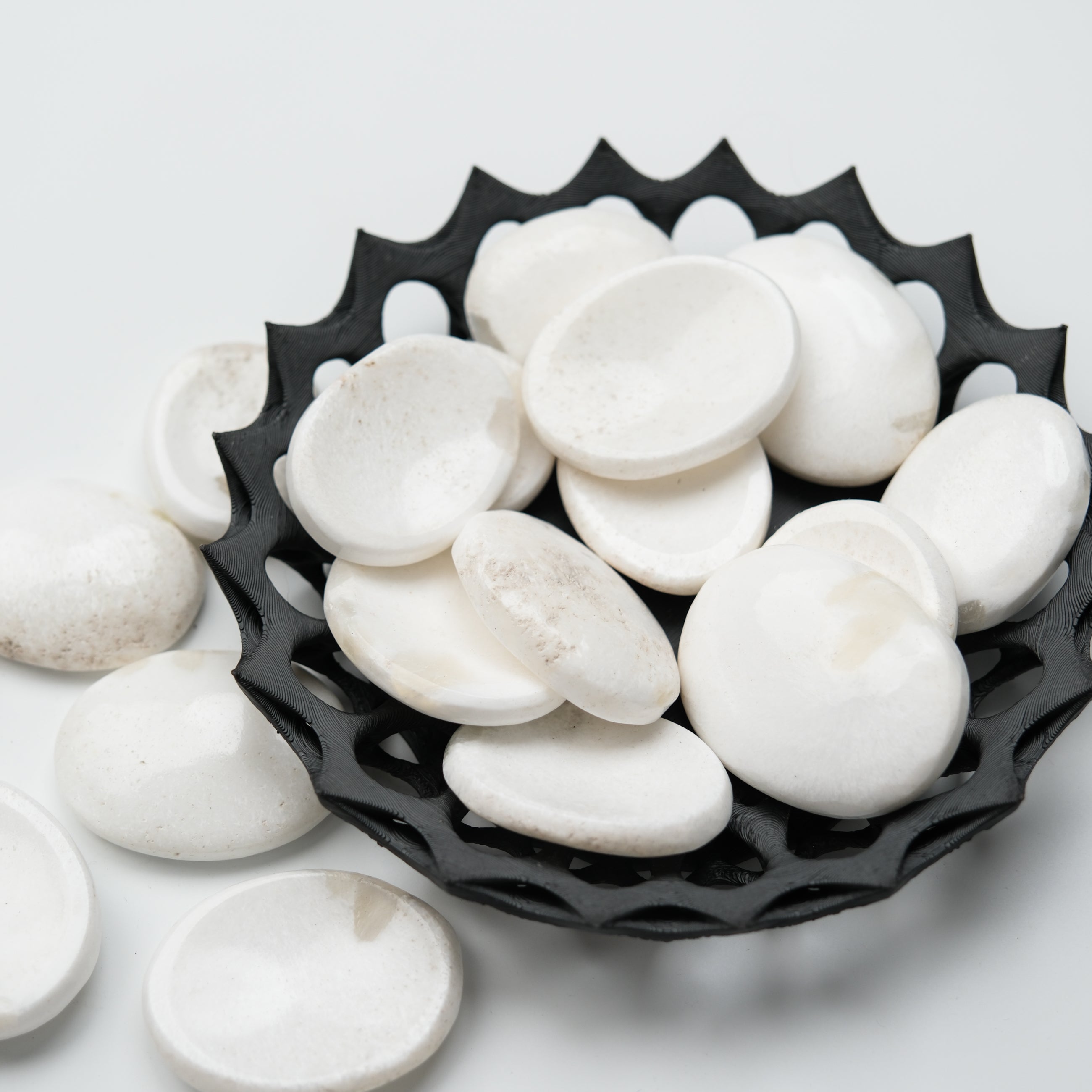 Scolecite worry stone from Noctis Studio, smooth polished gemstone with natural white and translucent appearance, handheld healing tool.