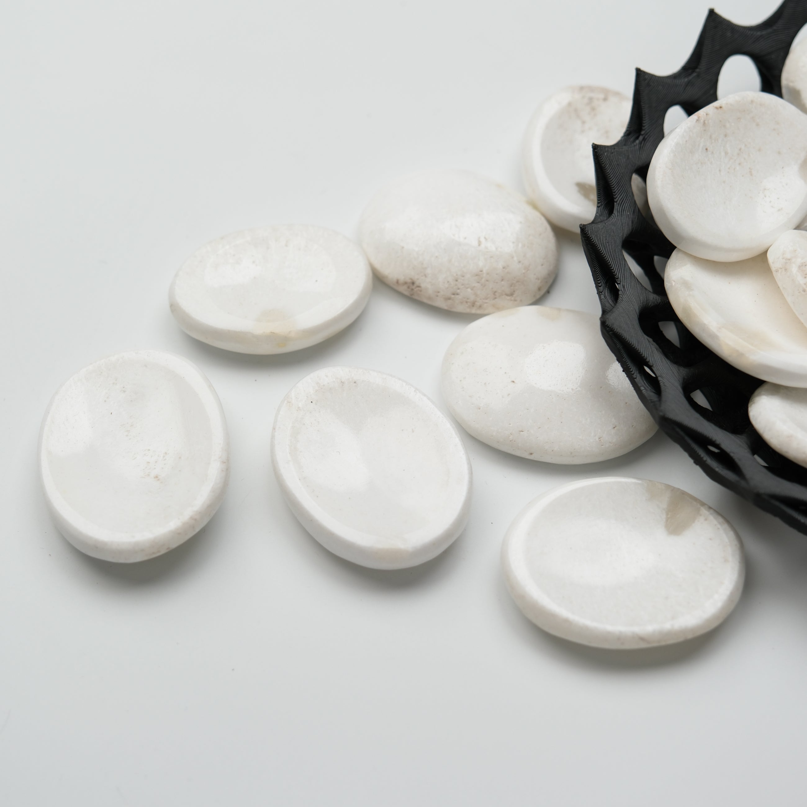 Scolecite worry stone from Noctis Studio featuring smooth, polished mineral with natural white and translucent patterns.