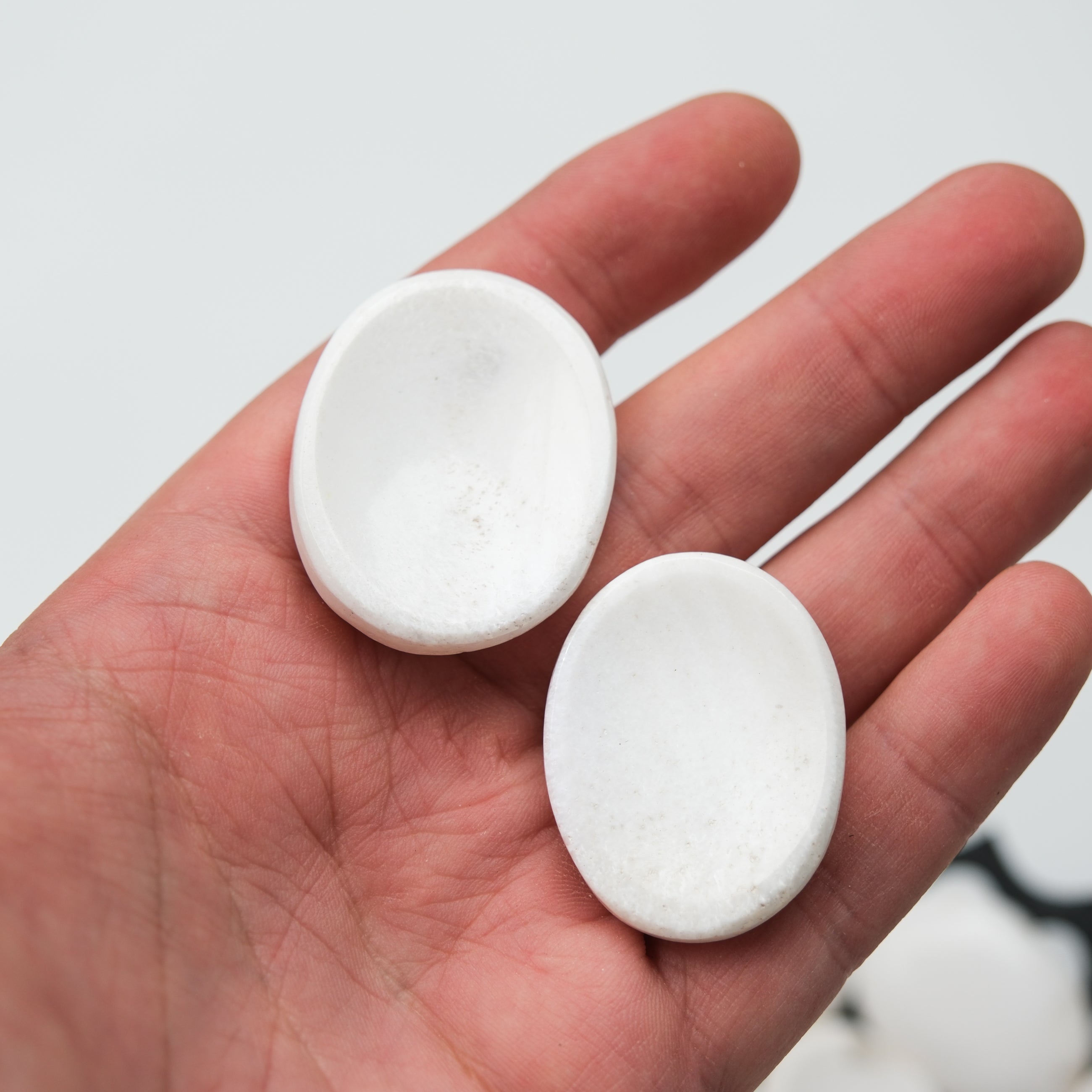 Scolecite worry stone from Noctis Studio, smooth polished mineral with natural white and translucent patterns, ideal for meditation.