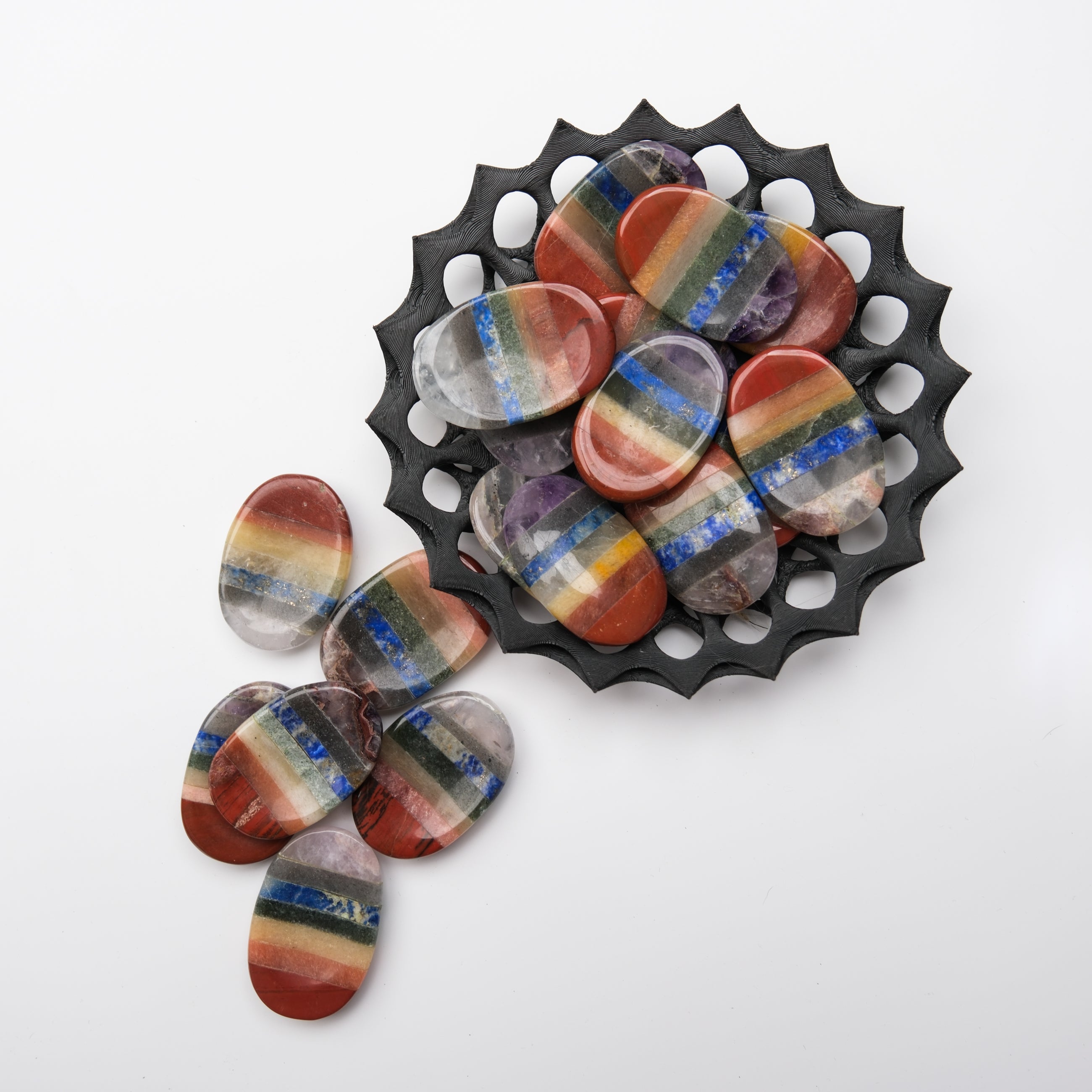 Smooth Chakra worry stone from Noctis Studio, rounded gemstone with chakra symbols engraved, ideal for stress relief and meditation.