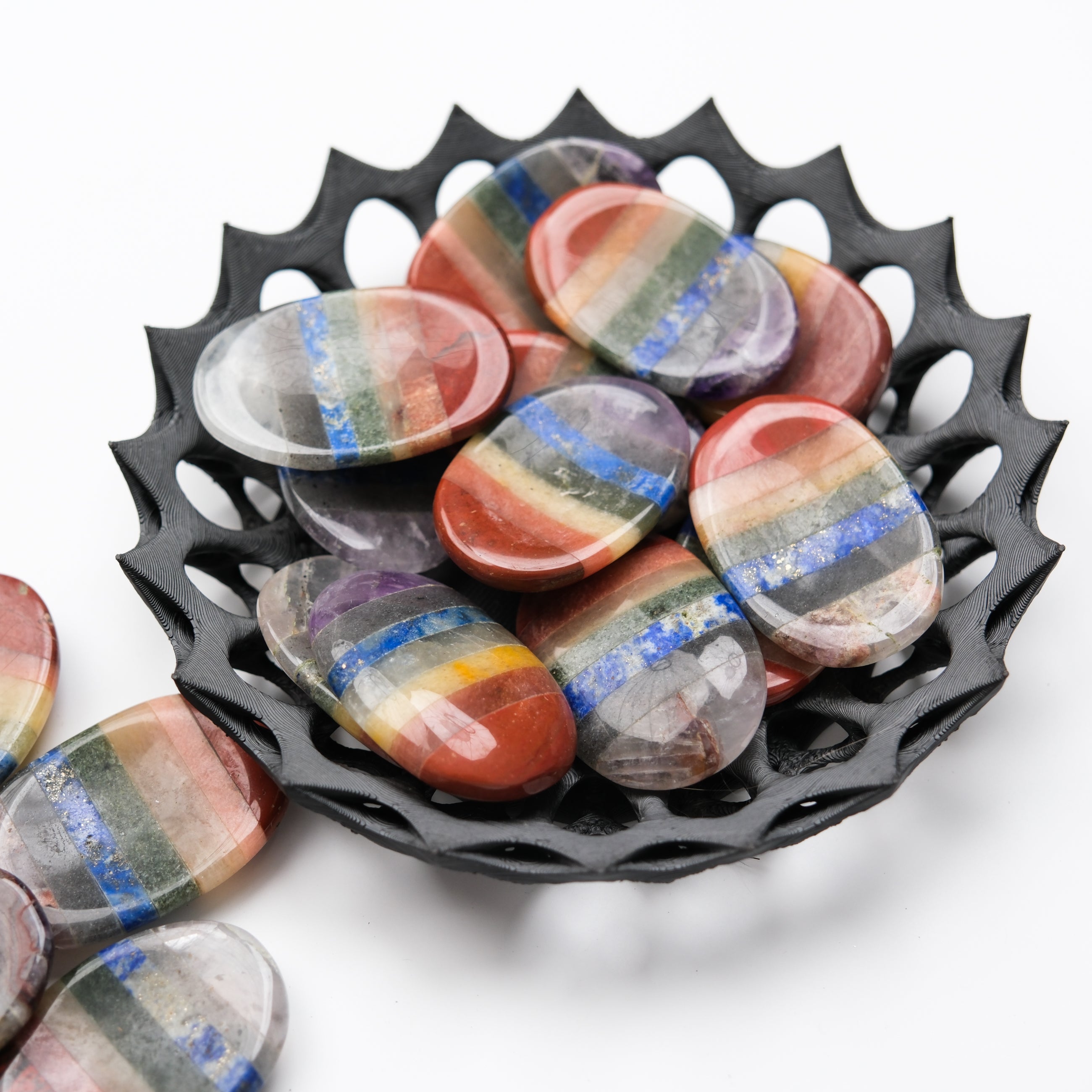 Noctis Studio Chakra worry stone with smooth, polished surface and engraved chakra symbols for meditation and stress relief.