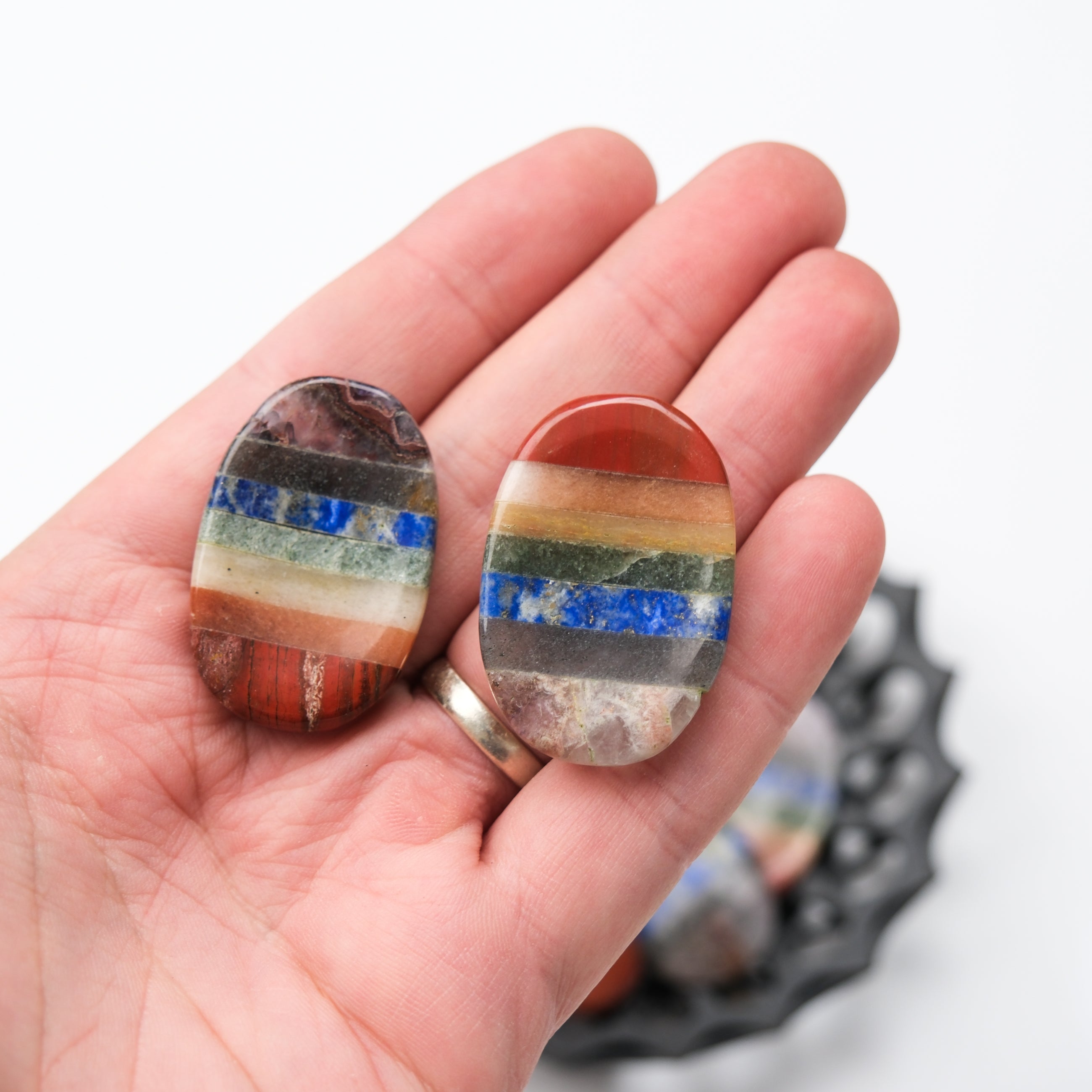 Smooth chakra worry stone by Noctis Studio, featuring polished gemstone with chakra symbols for calming stress relief.