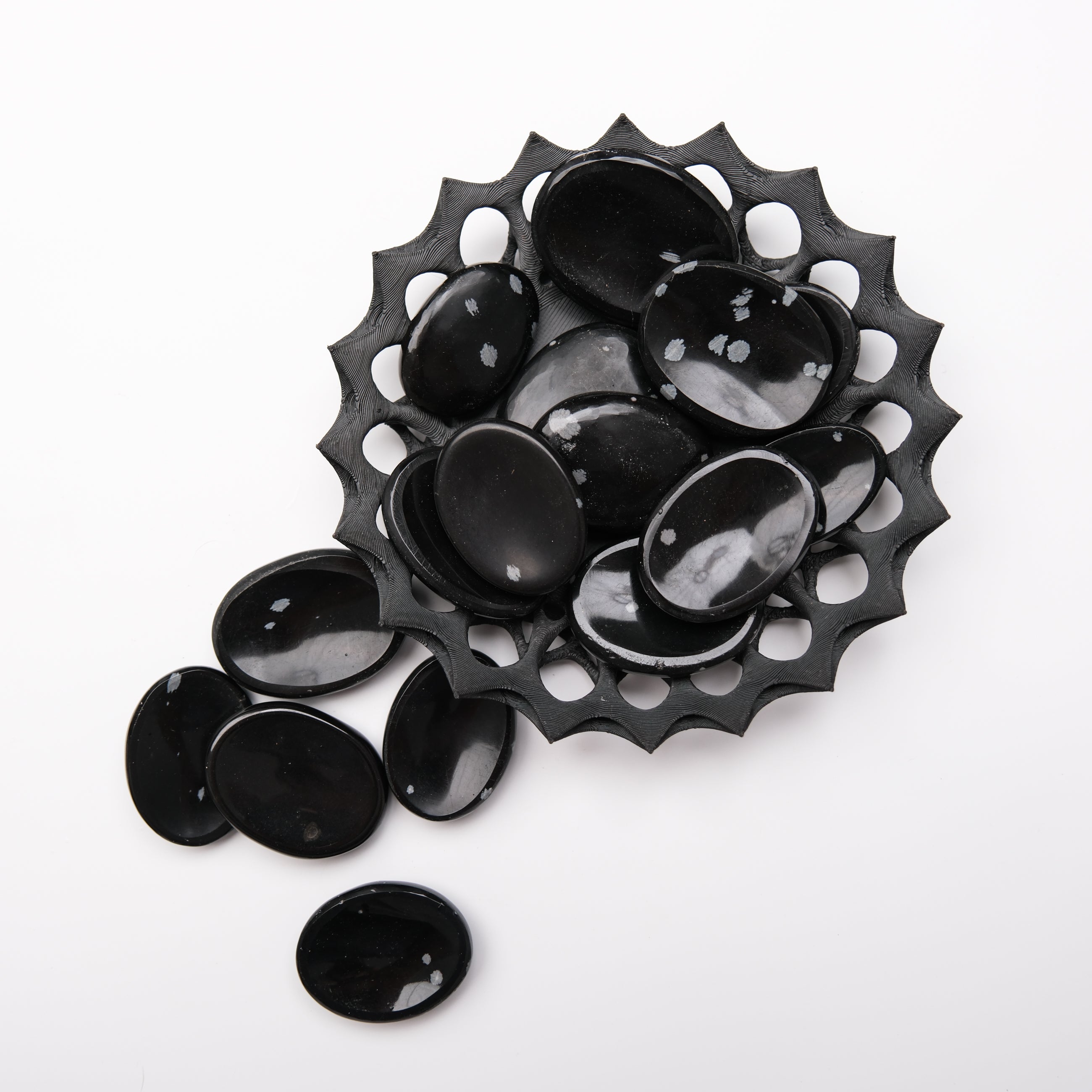 Snowflake Obsidian worry stone from Noctis Studio with smooth, polished surface and unique black and white snowflake pattern.