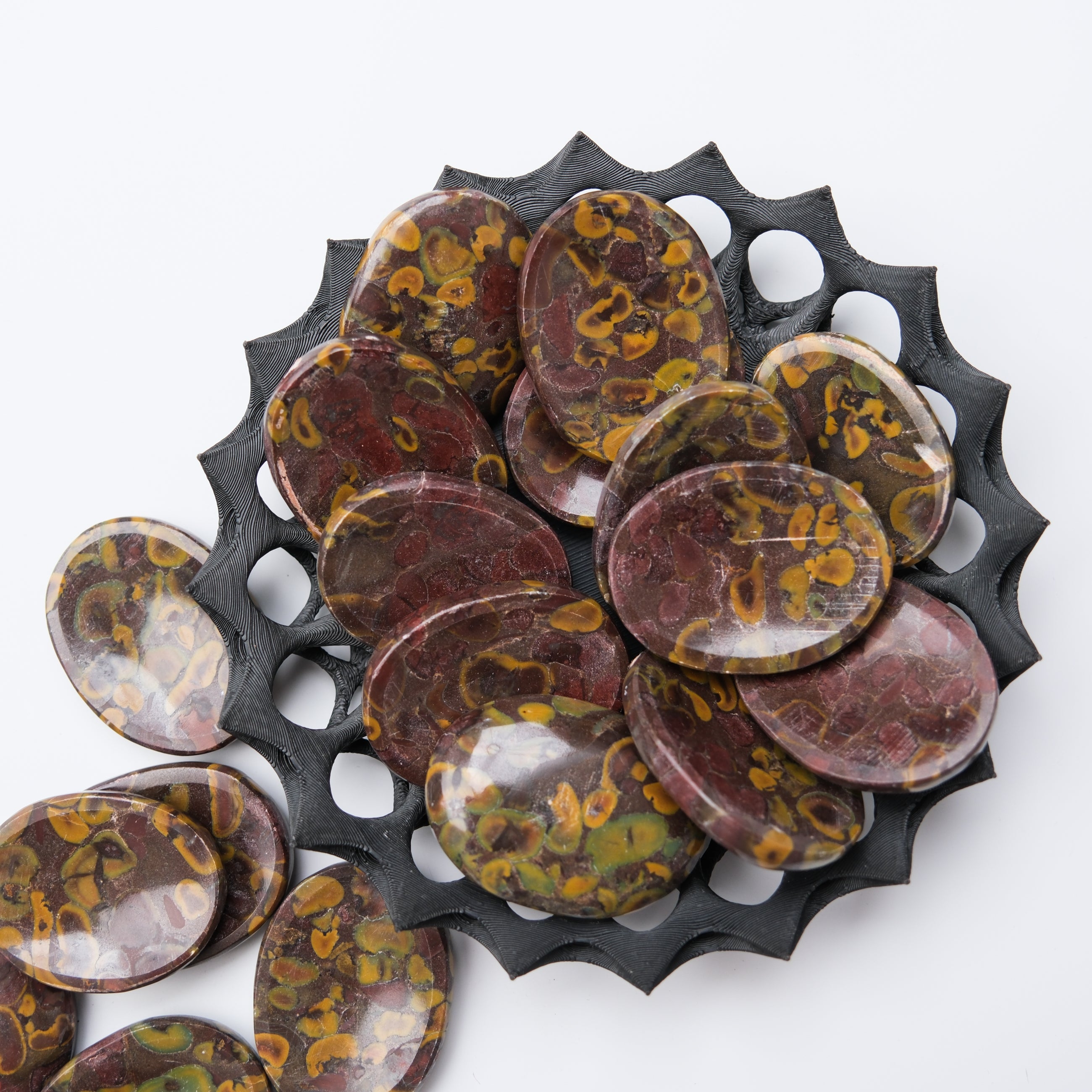 Smooth Fruit Jasper worry stone from Noctis Studio, featuring polished, rounded gemstone with natural orange, yellow, and red hues.