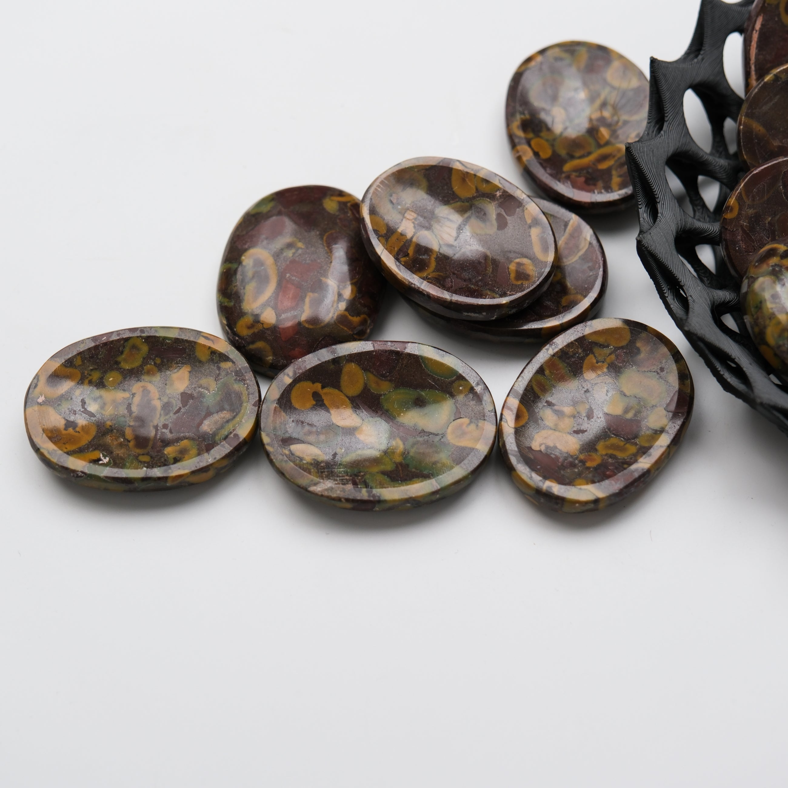 Smooth Fruit Jasper worry stone from Noctis Studio, polished gemstone for stress relief and meditation.