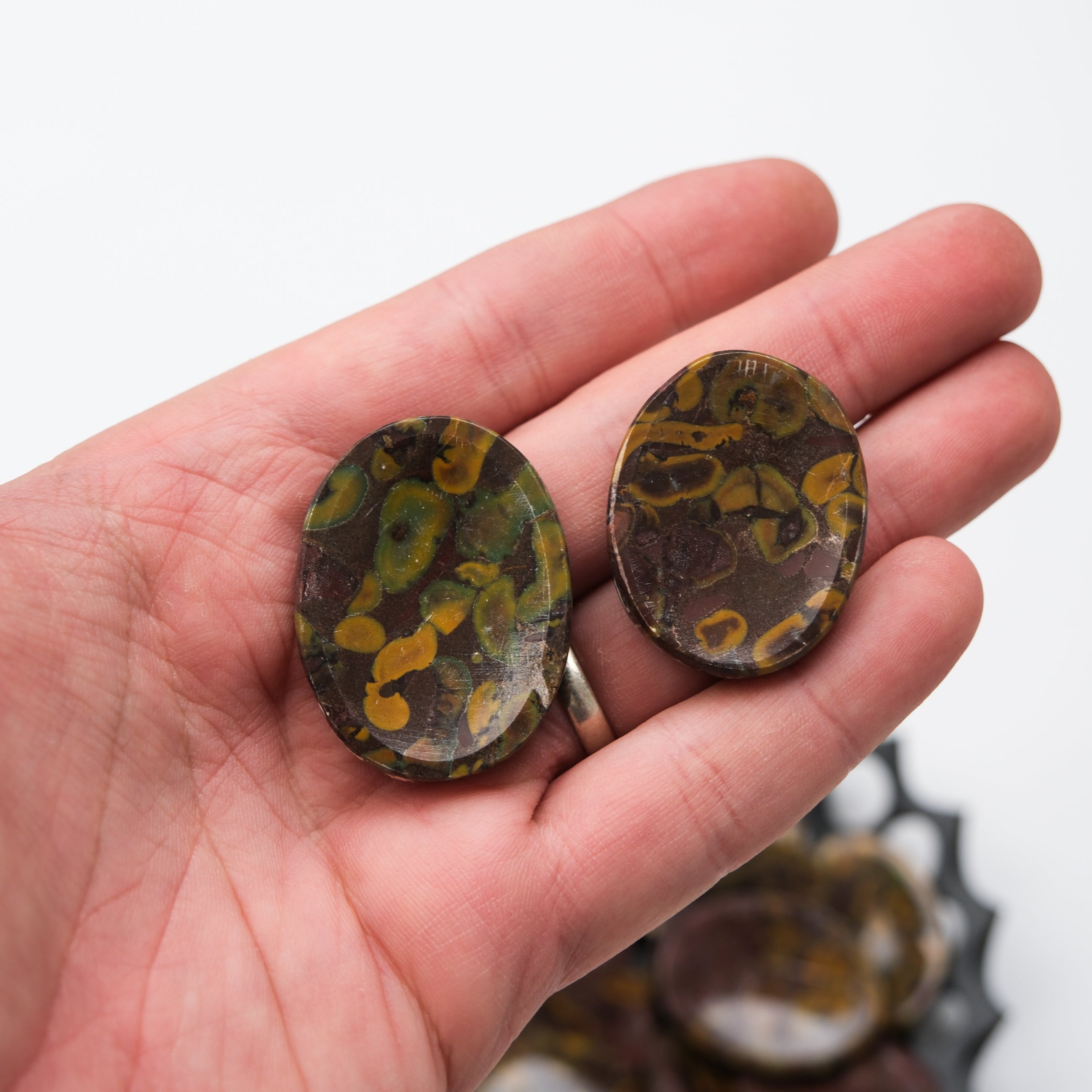 Smooth fruit Jasper worry stone from Noctis Studio, crafted for calming grip and relaxation.