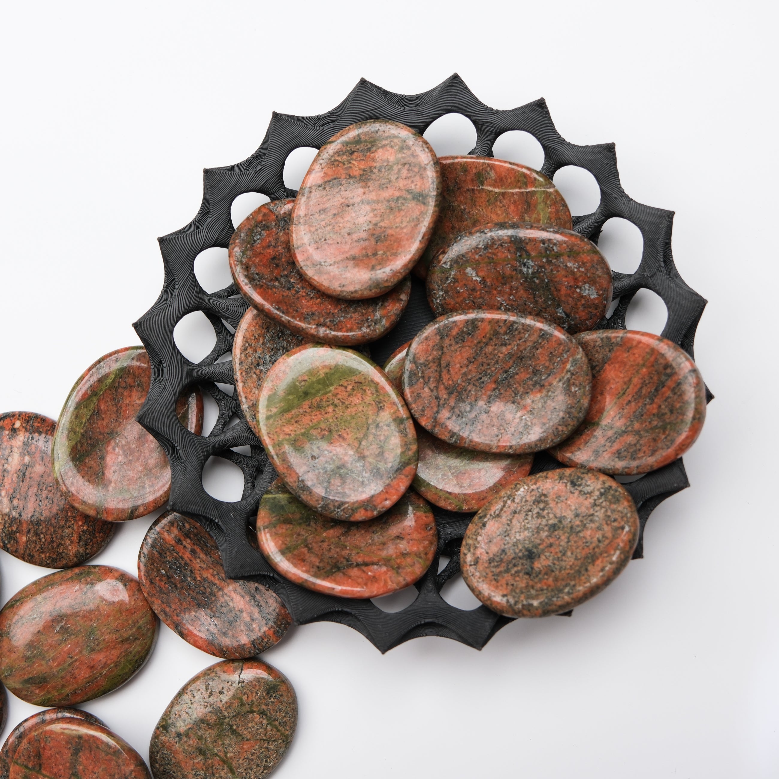 Unakite worry stone from Noctis Studio, smooth polished gemstone for meditation or stress relief, shown with natural green and pink hues.