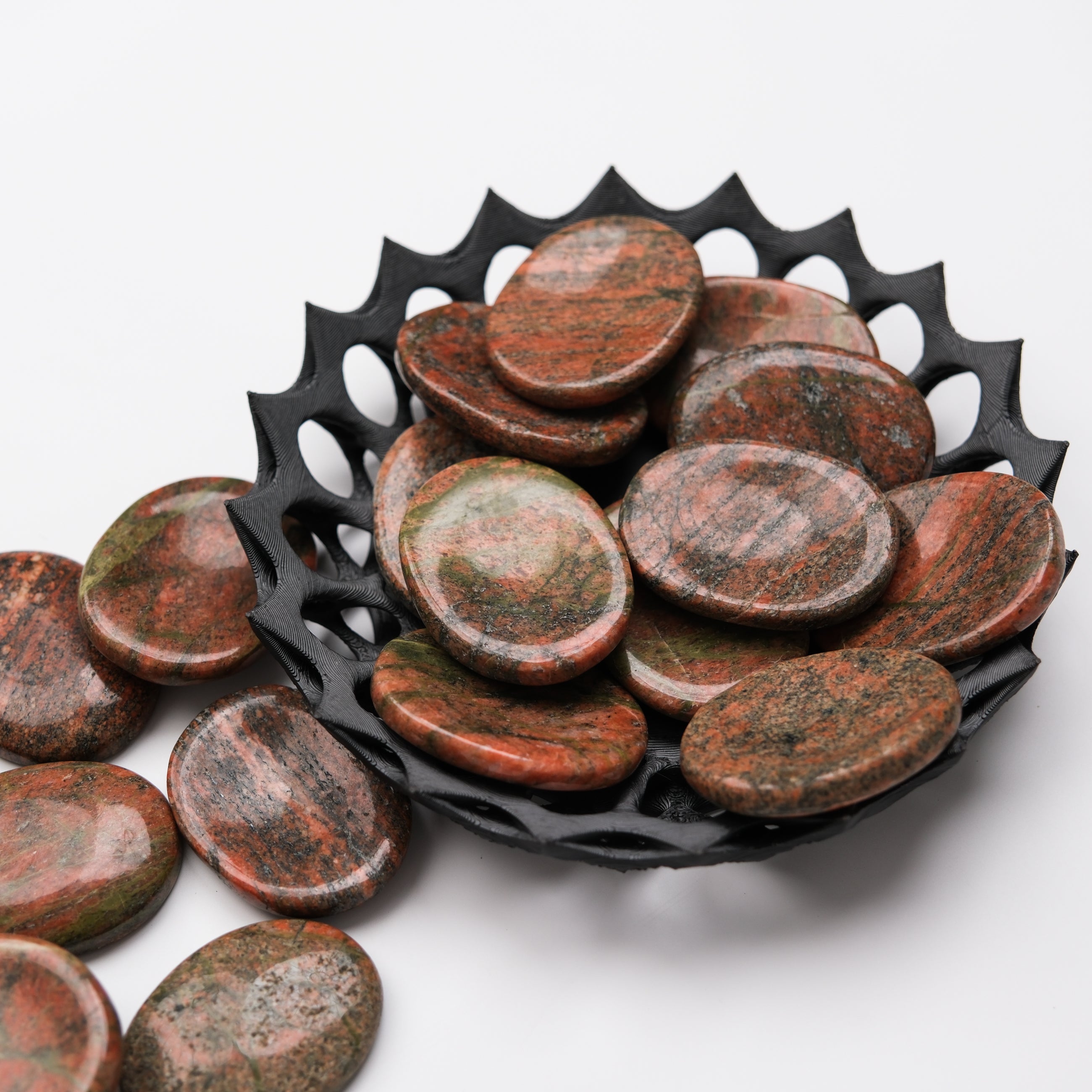 Unakite worry stone by Noctis Studio, smooth polished gemstone for stress relief and meditation, shown in close-up.