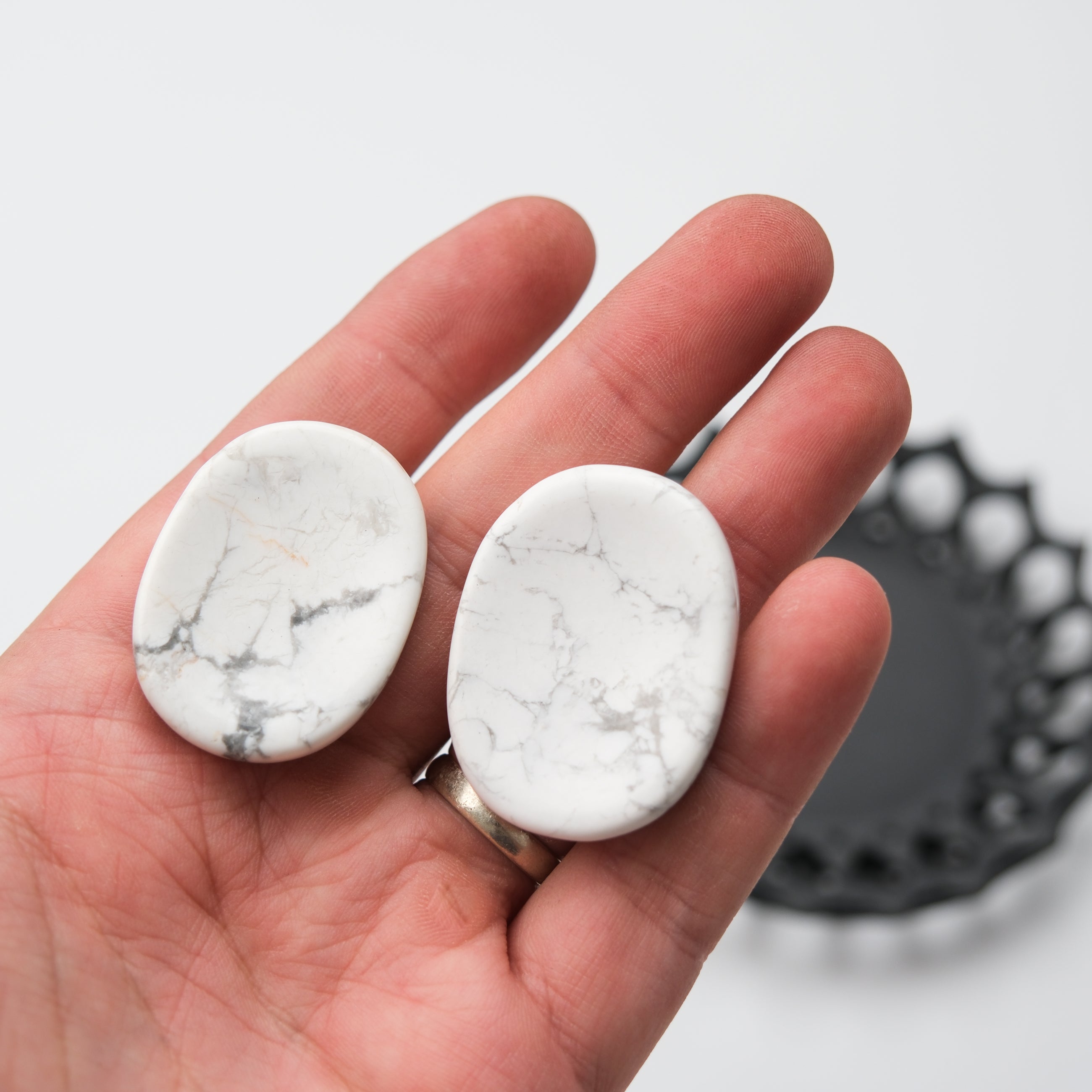 White howlite worry stone from Noctis Studio, smooth polished worry stone with calming white and gray marbled patterns.