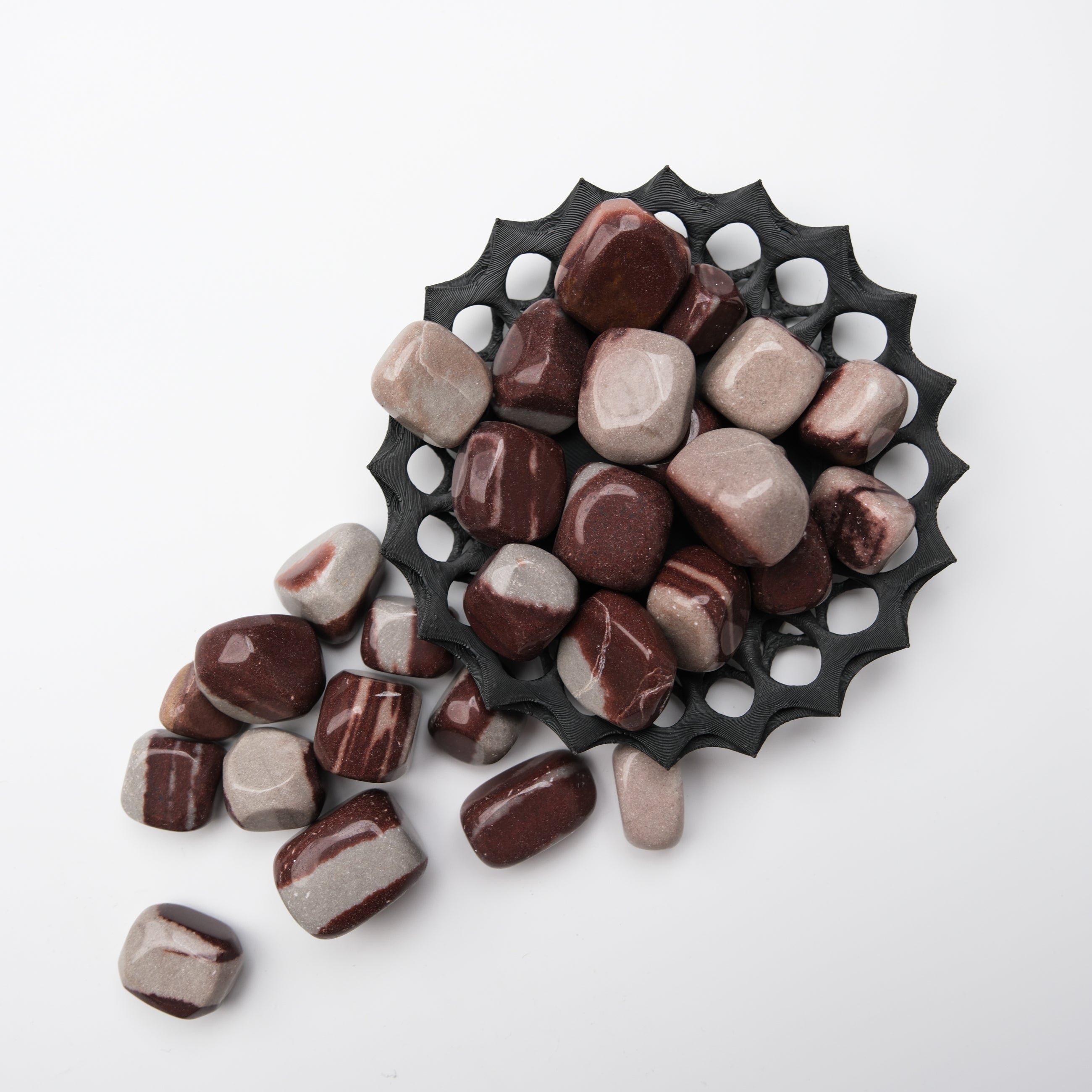 Shiva Lingam tumble stone from Noctis Studio, smooth polished mineral with natural patterns, used for meditation and spiritual practices.