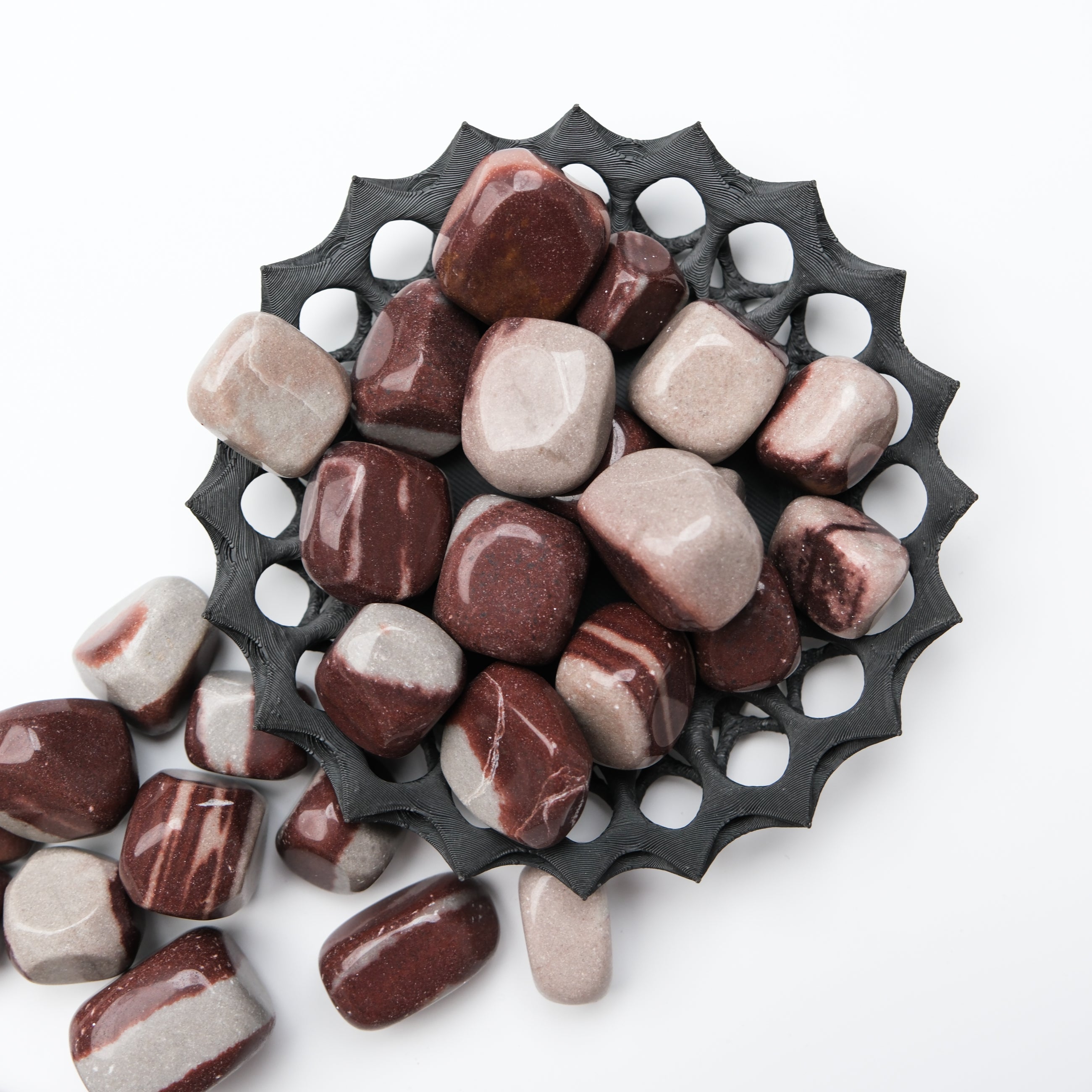 Noctis Studio Shiva Lingam tumble stone, polished mineral with smooth surface and natural earthy colors, used for meditation and healing.