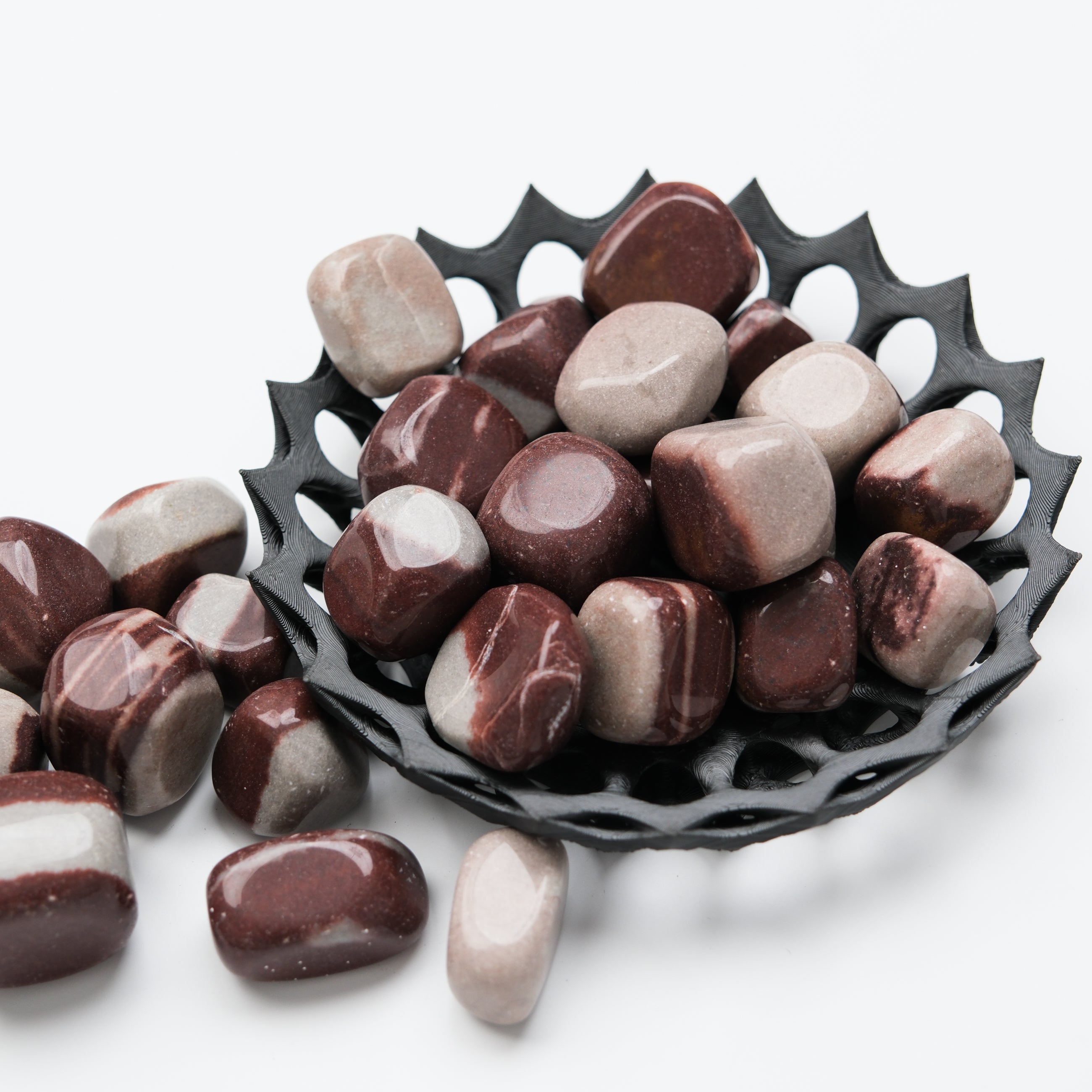 Noctis Studio Shiva Lingam Tumble Stone showcasing smooth, polished gemstone with natural patterns and vibrant colors.