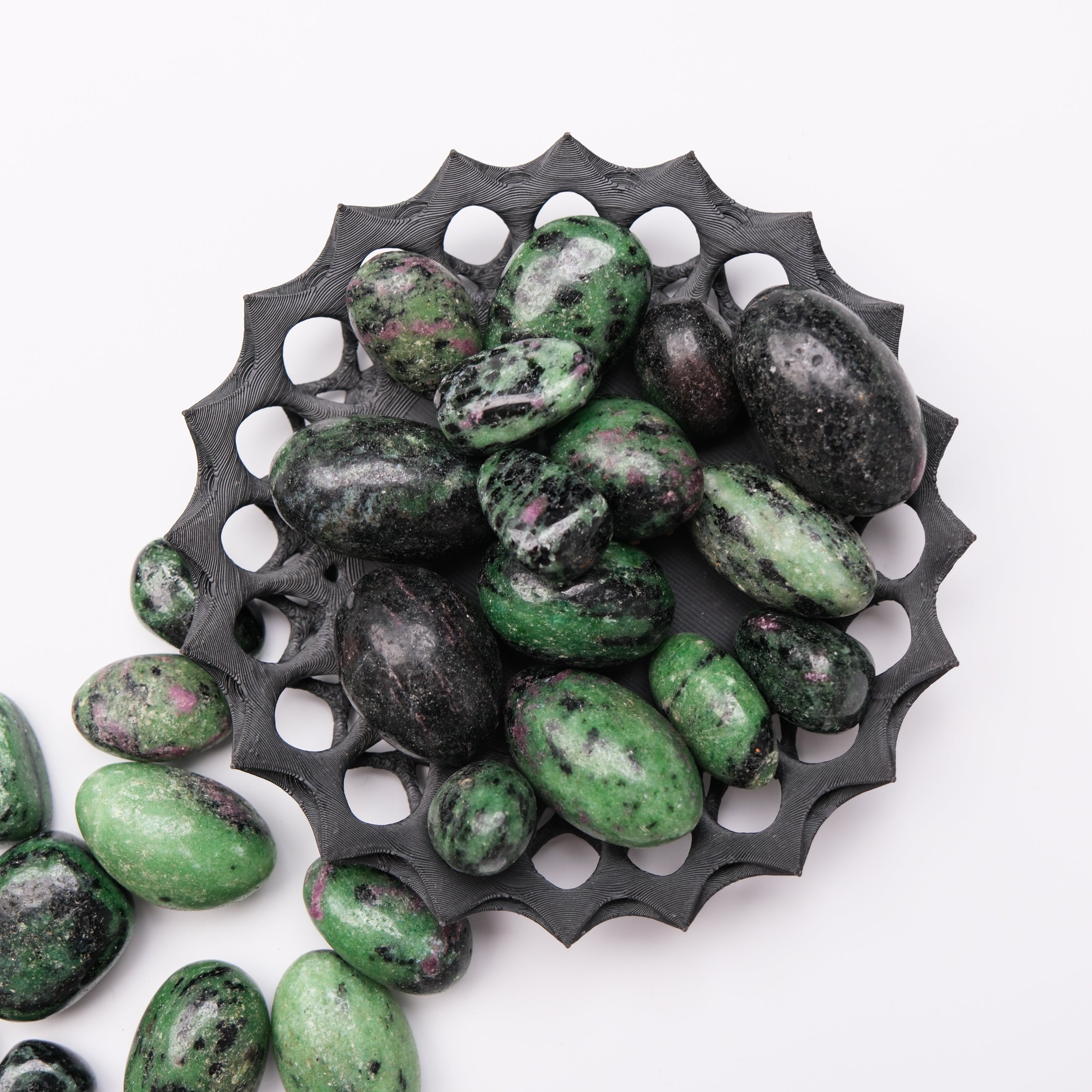 Ruby in Zoisite tumble stone from Noctis Studio, showing vibrant red and green mineral patterns in a polished gemstone.
