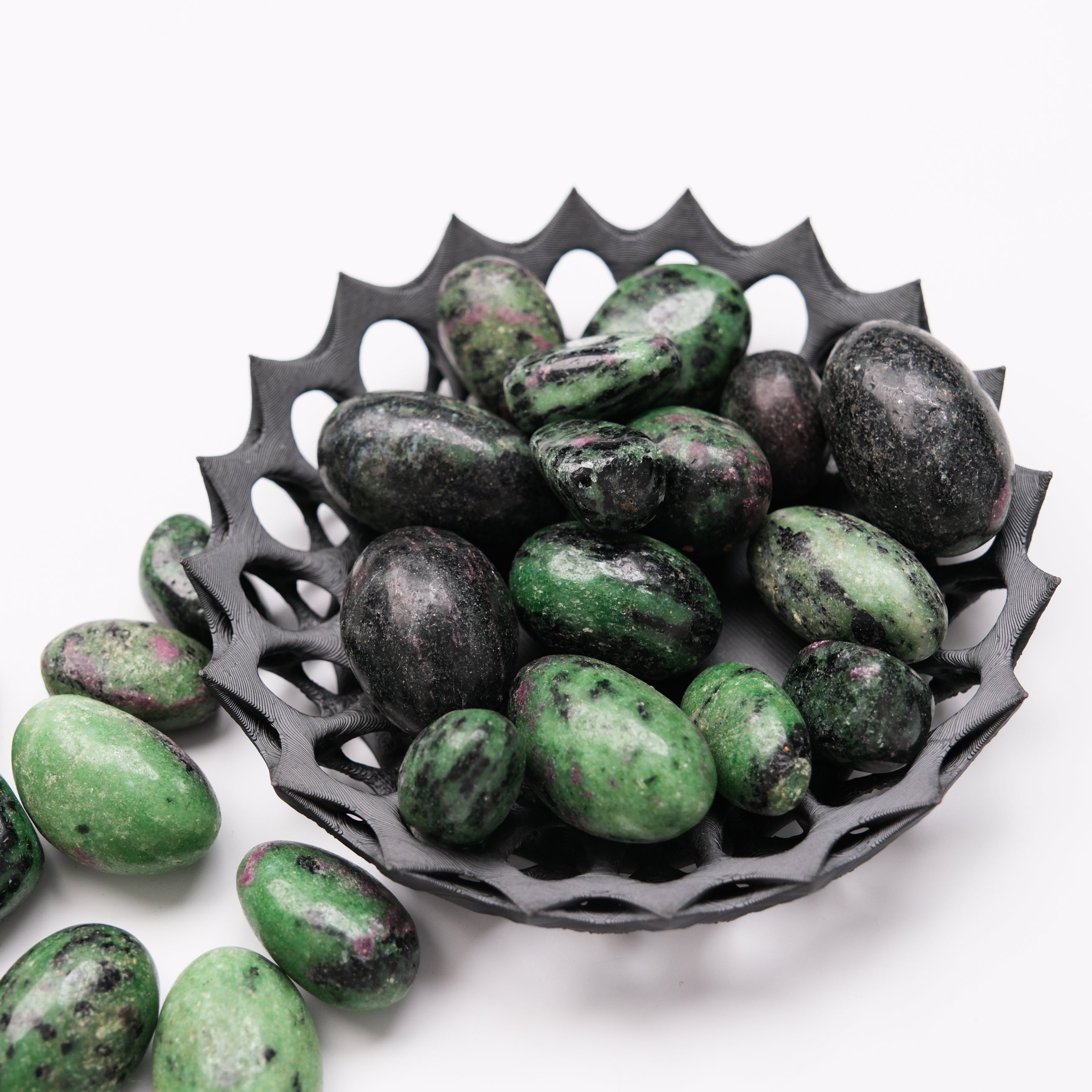 Ruby in Zoisite tumble stone from Noctis Studio, showing vibrant red and green mineral patterns in a polished gemstone.
