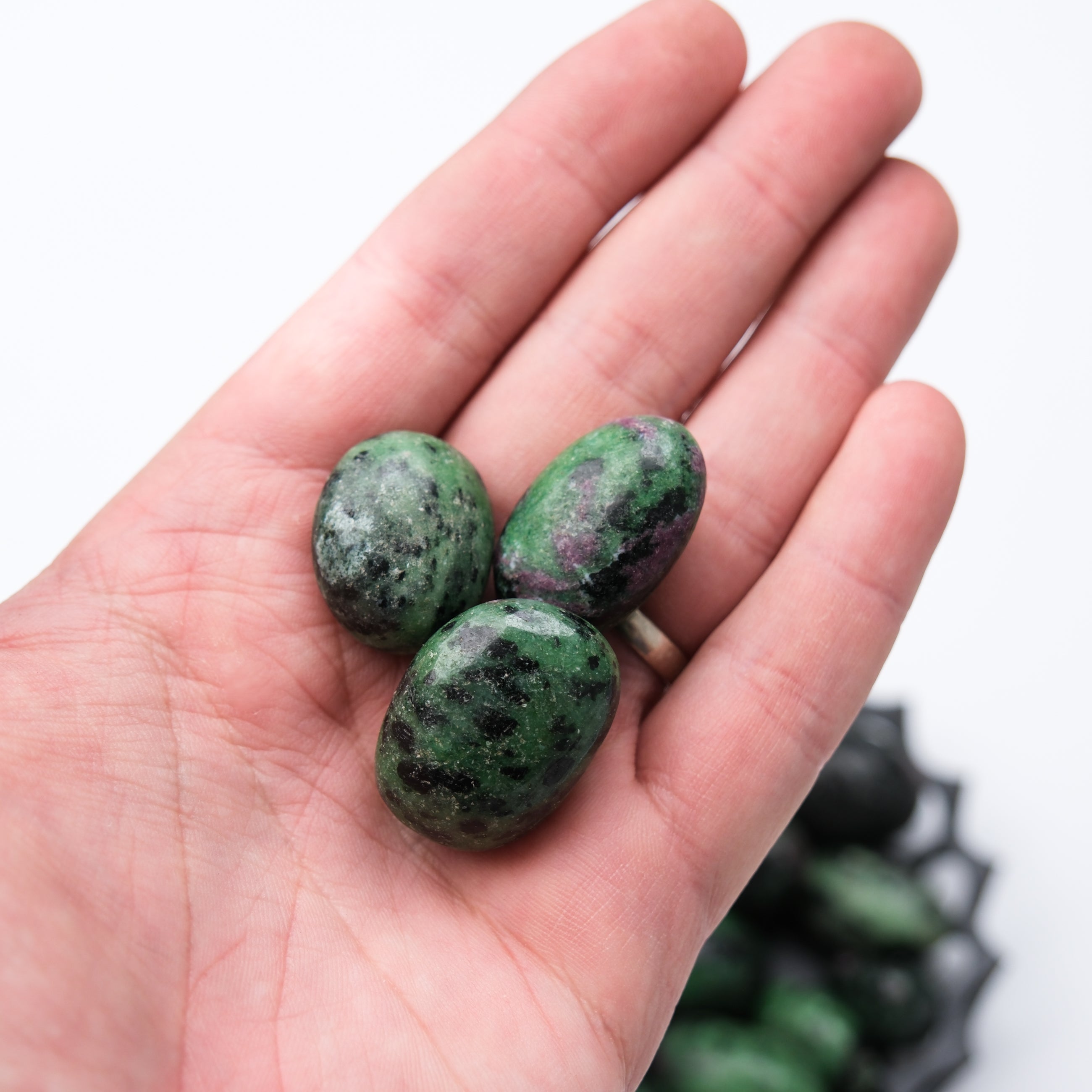 Ruby in Zoisite tumble stone from Noctis Studio, showcasing a polished mineral with vibrant red and green hues.