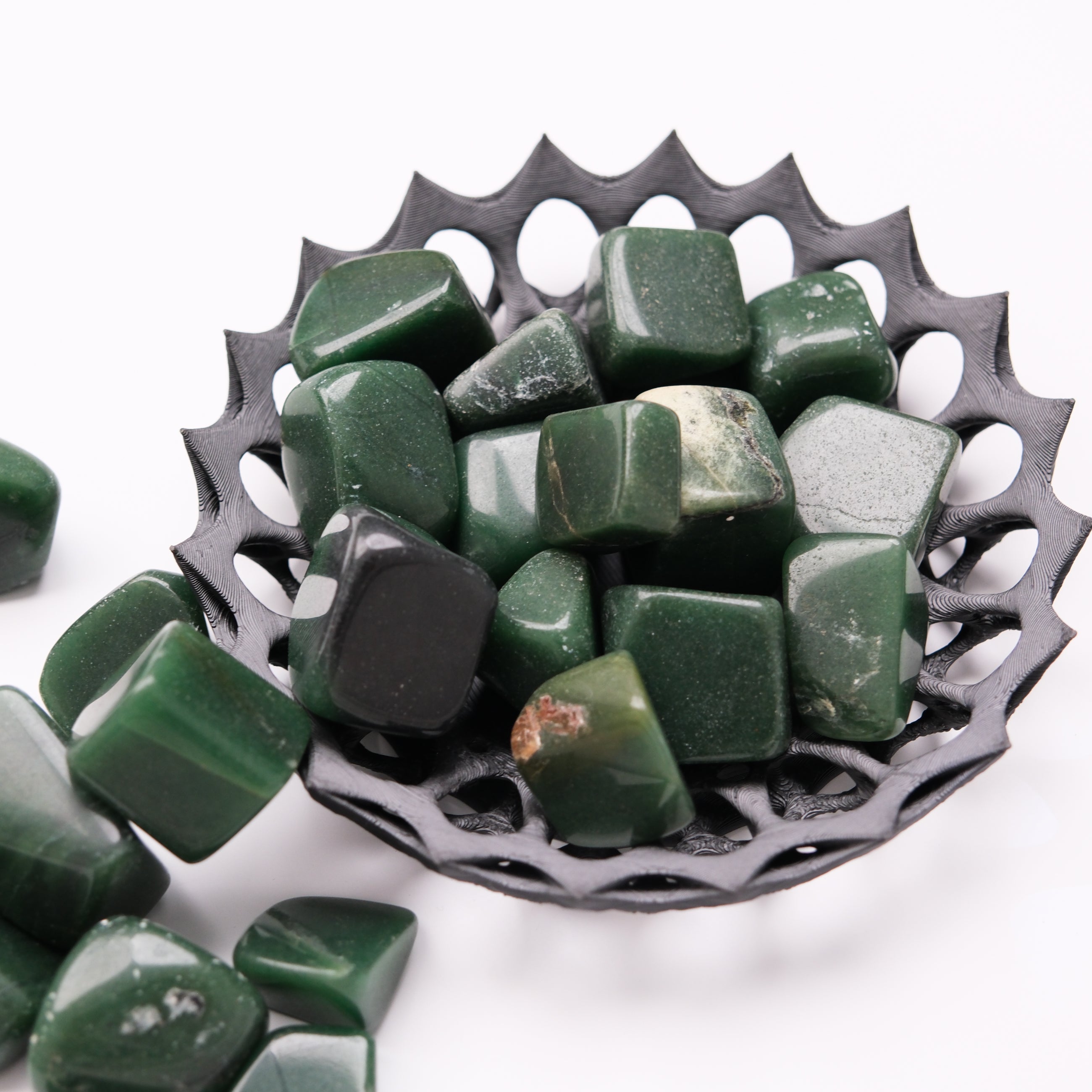 Dark green aventurine tumble stone from Noctis Studio, showcasing its polished, smooth surface and vibrant green color.