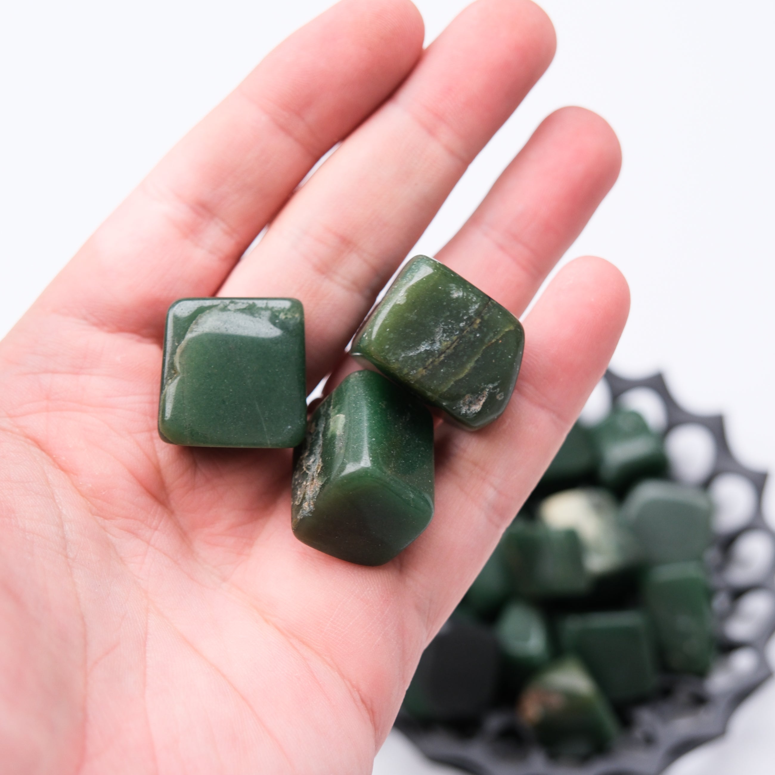 Dark green aventurine tumble stone from Noctis Studio, polished mineral with smooth surface and natural green coloration.