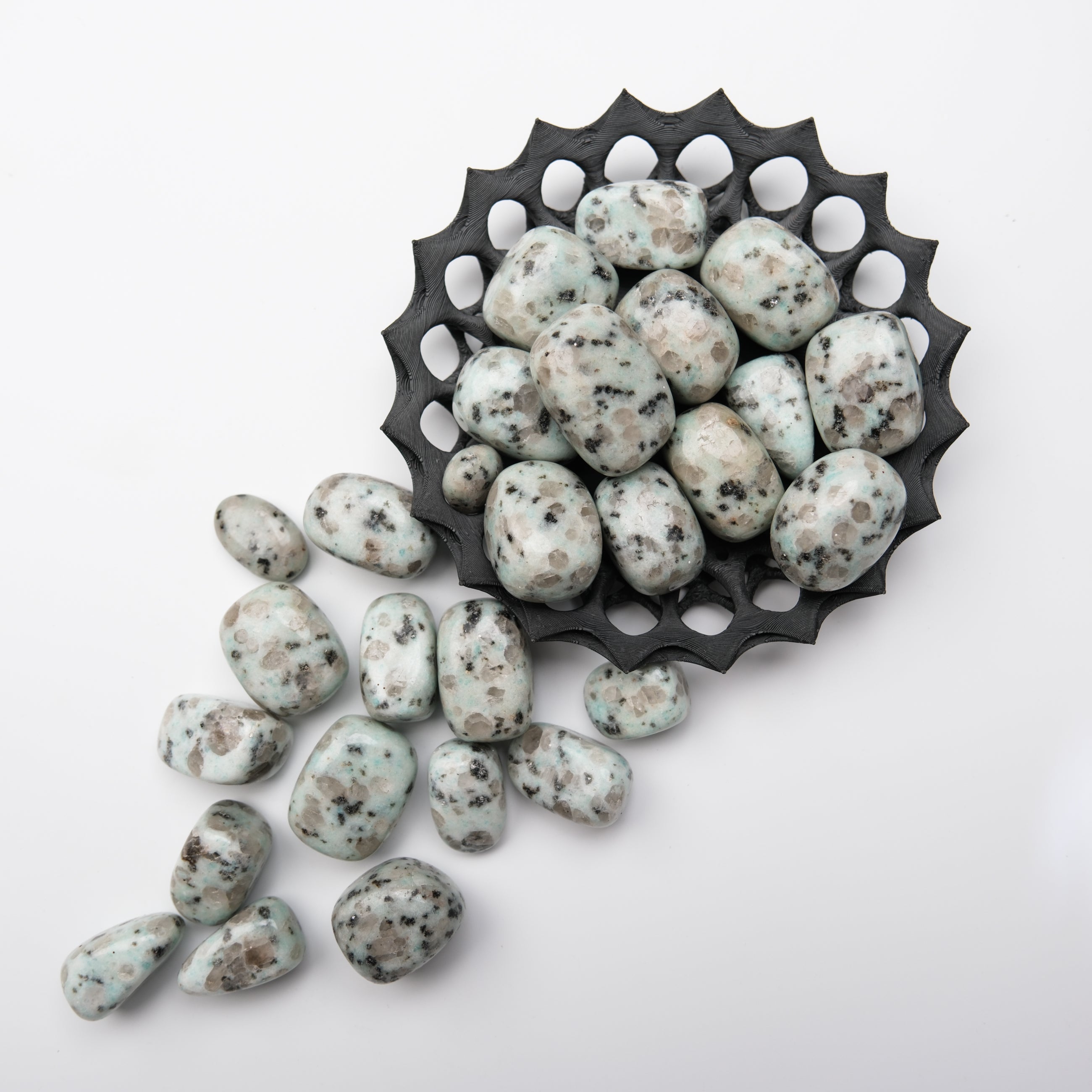 Kiwi Jasper tumble stone from Noctis Studio showing vibrant green and brown patterns, smooth polished surface.