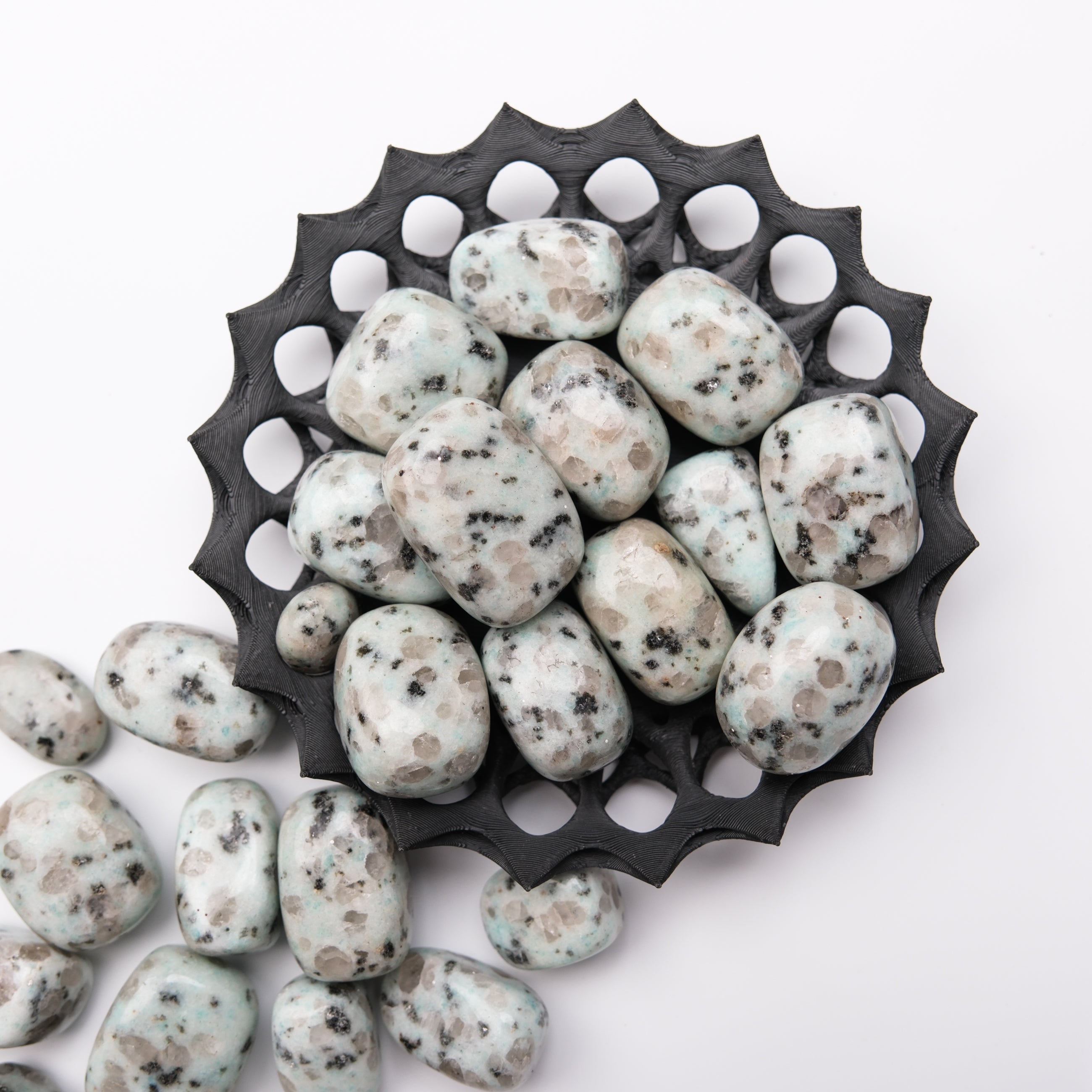 Kiwi Jasper tumble stone from Noctis Studio showing vibrant green and brown patterns, polished and smooth for decorative or healing use.