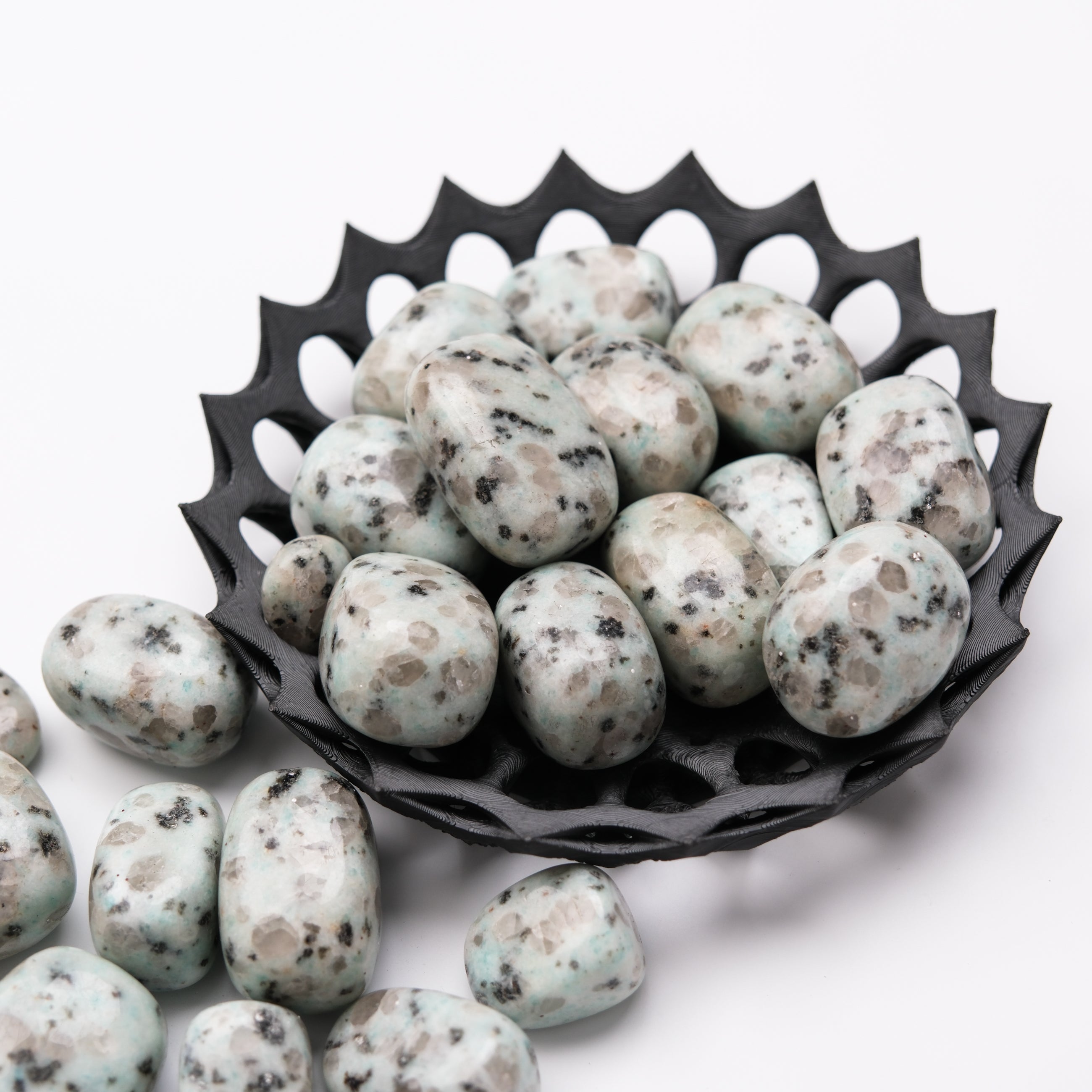 Kiwi Jasper tumble stone from Noctis Studio, smooth polished mineral with vibrant green and earthy brown tones, raw and natural appearance.