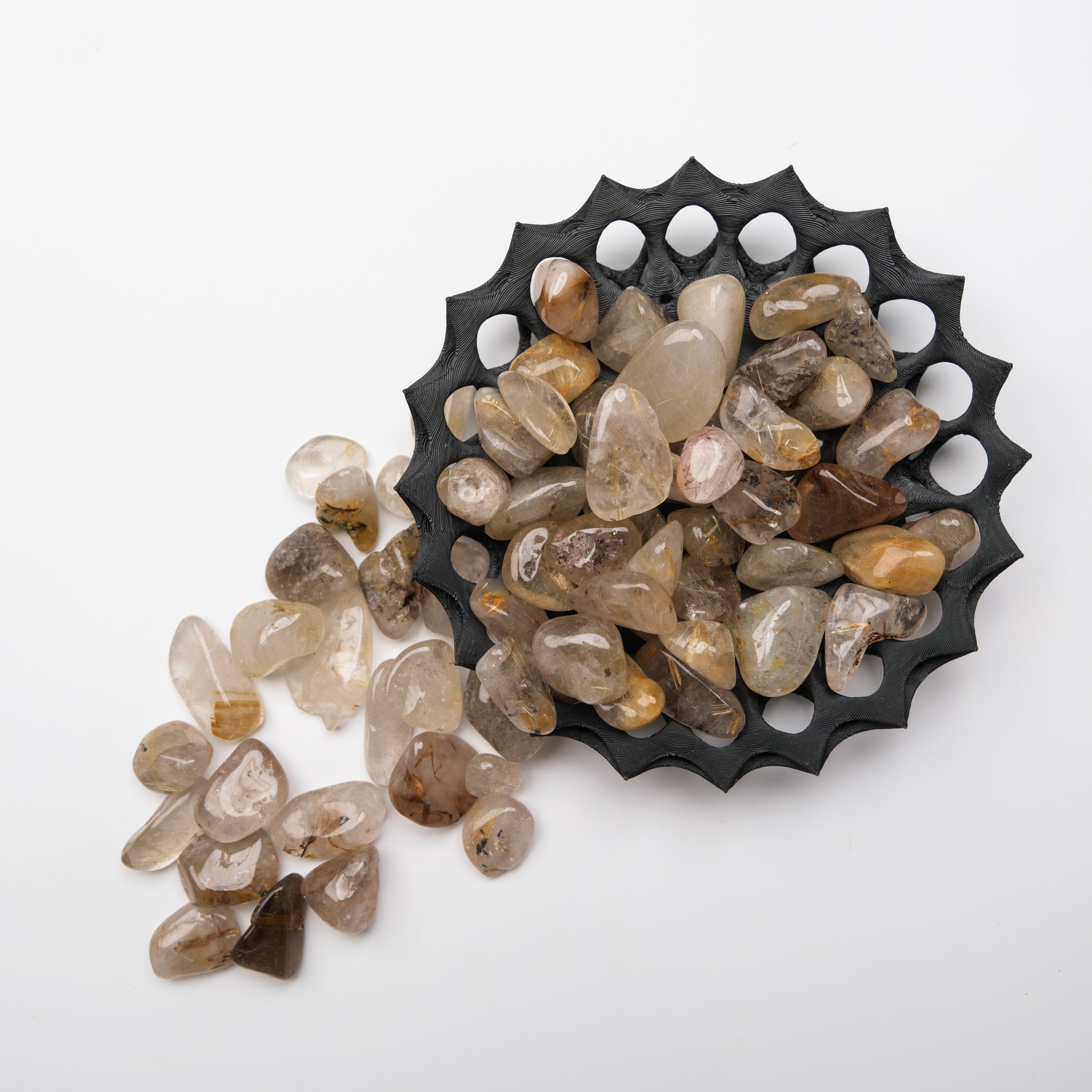 Golden rutilated quartz tumble stone from Noctis Studio, polished gemstone with golden needle inclusions, smooth surface, and vibrant color.