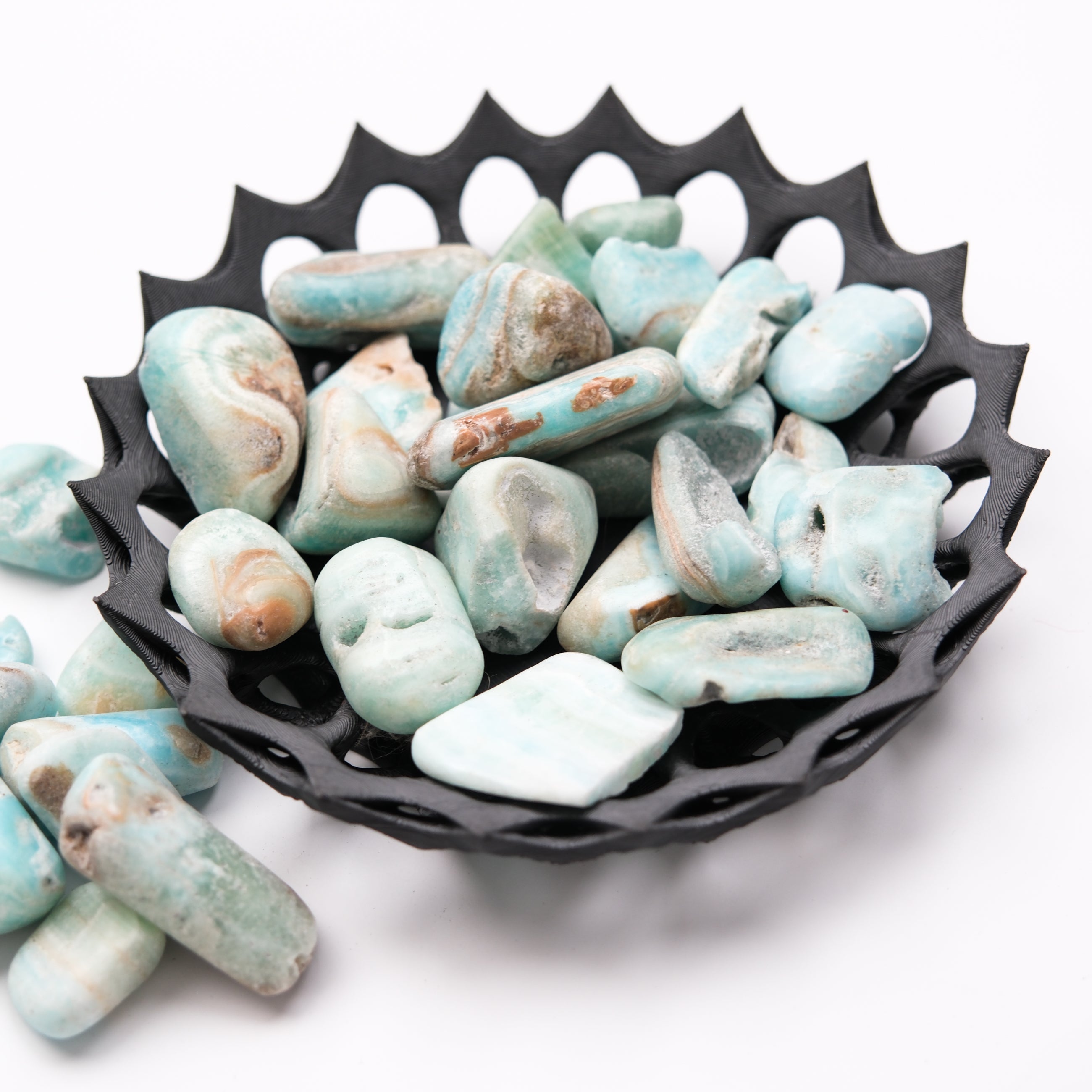 Caribbean Calcite tumble stone from Noctis Studio, smooth polished mineral with vibrant blue and orange hues, showcasing natural stone patterns.