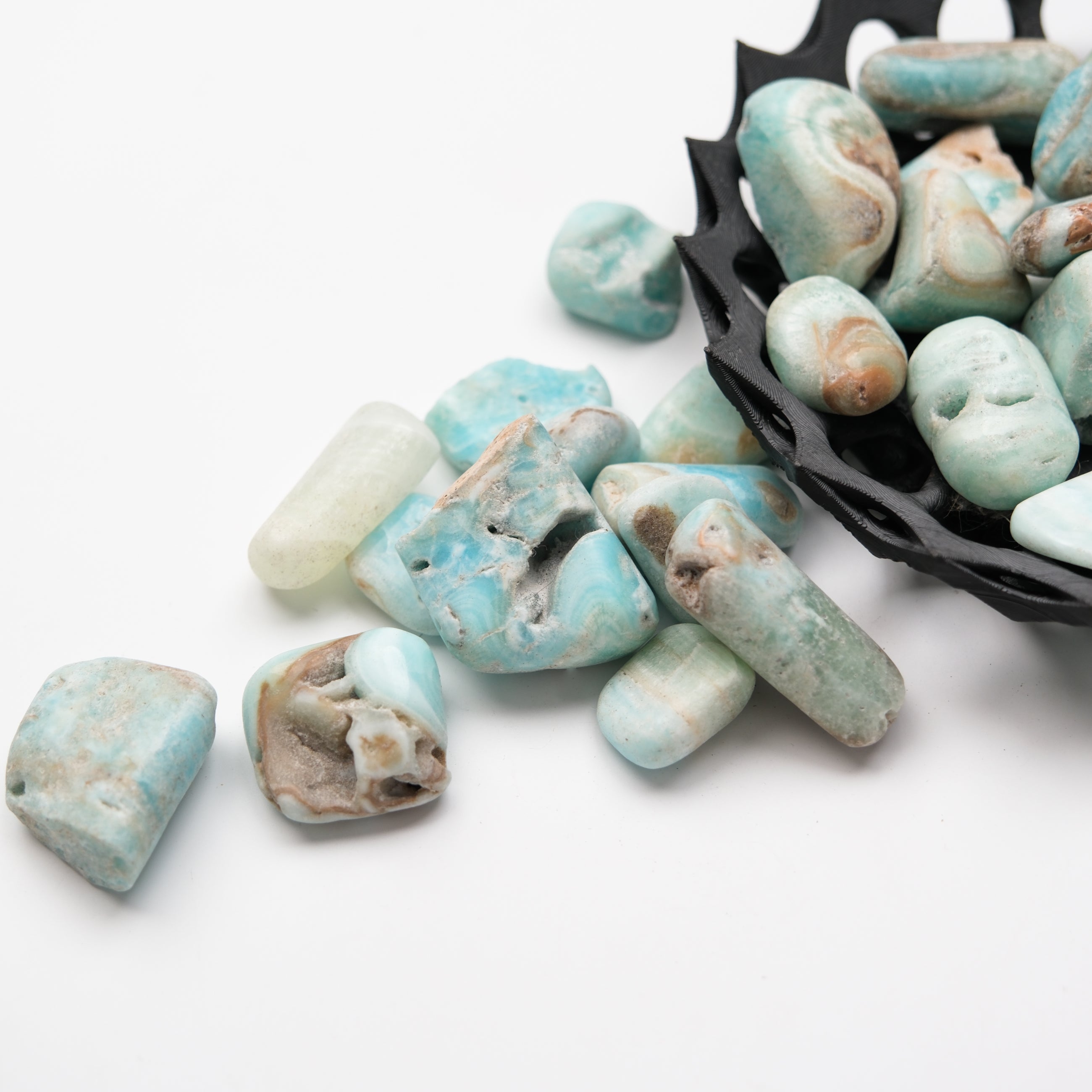 Caribbean Calcite tumble stone by Noctis Studio showing smooth, polished blue and white mineral with natural patterns and textures.