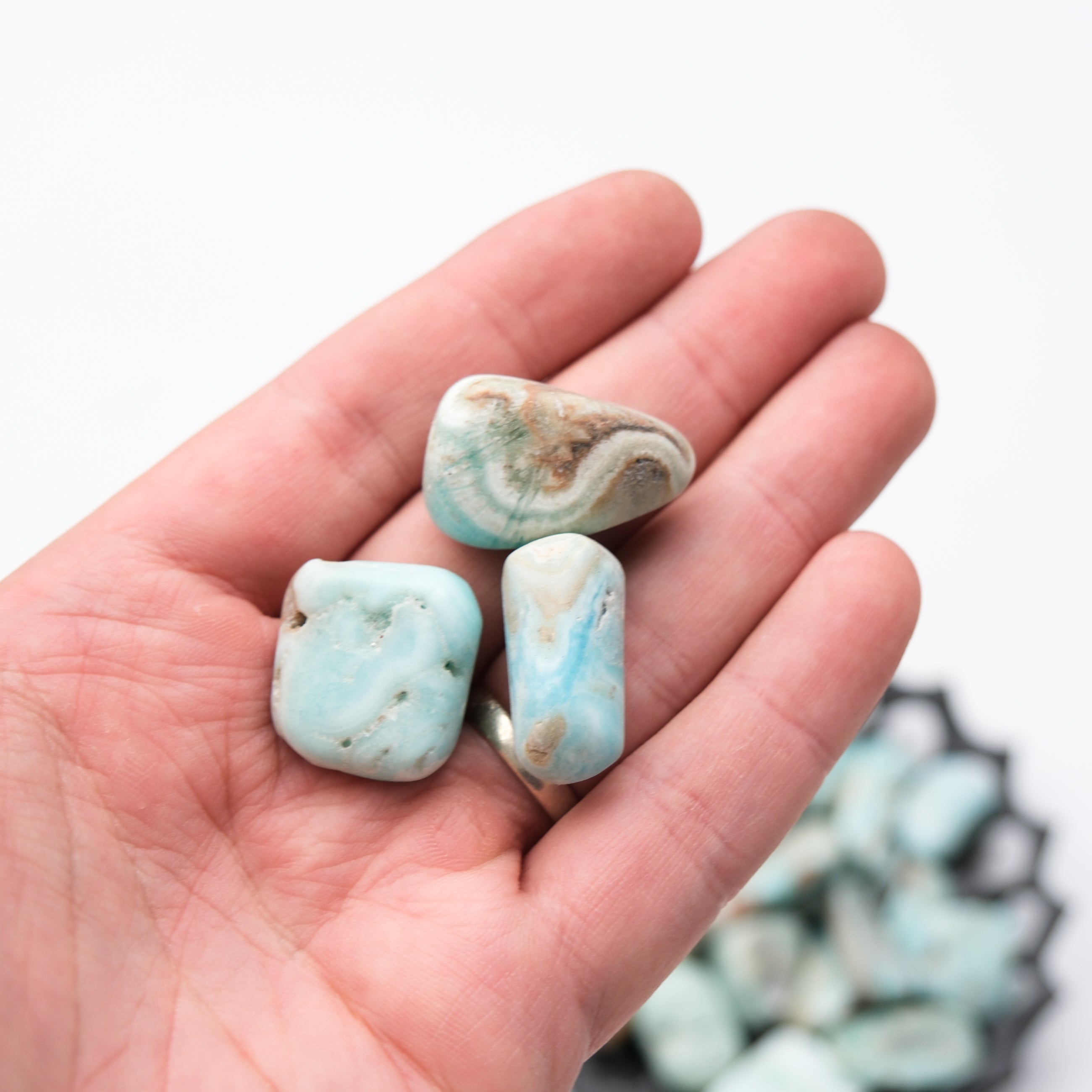 Caribbean Calcite tumble stone from Noctis Studio, showcasing smooth, polished mineral with vibrant blue and green hues.