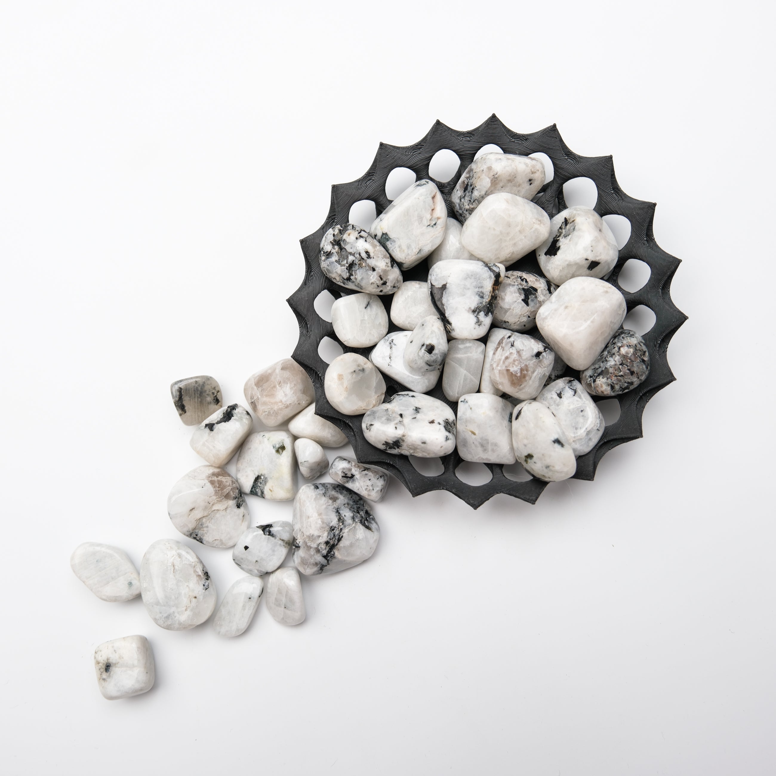Polished moonstone tumble stone from Noctis Studio showing its smooth surface and luminous, iridescent glow.