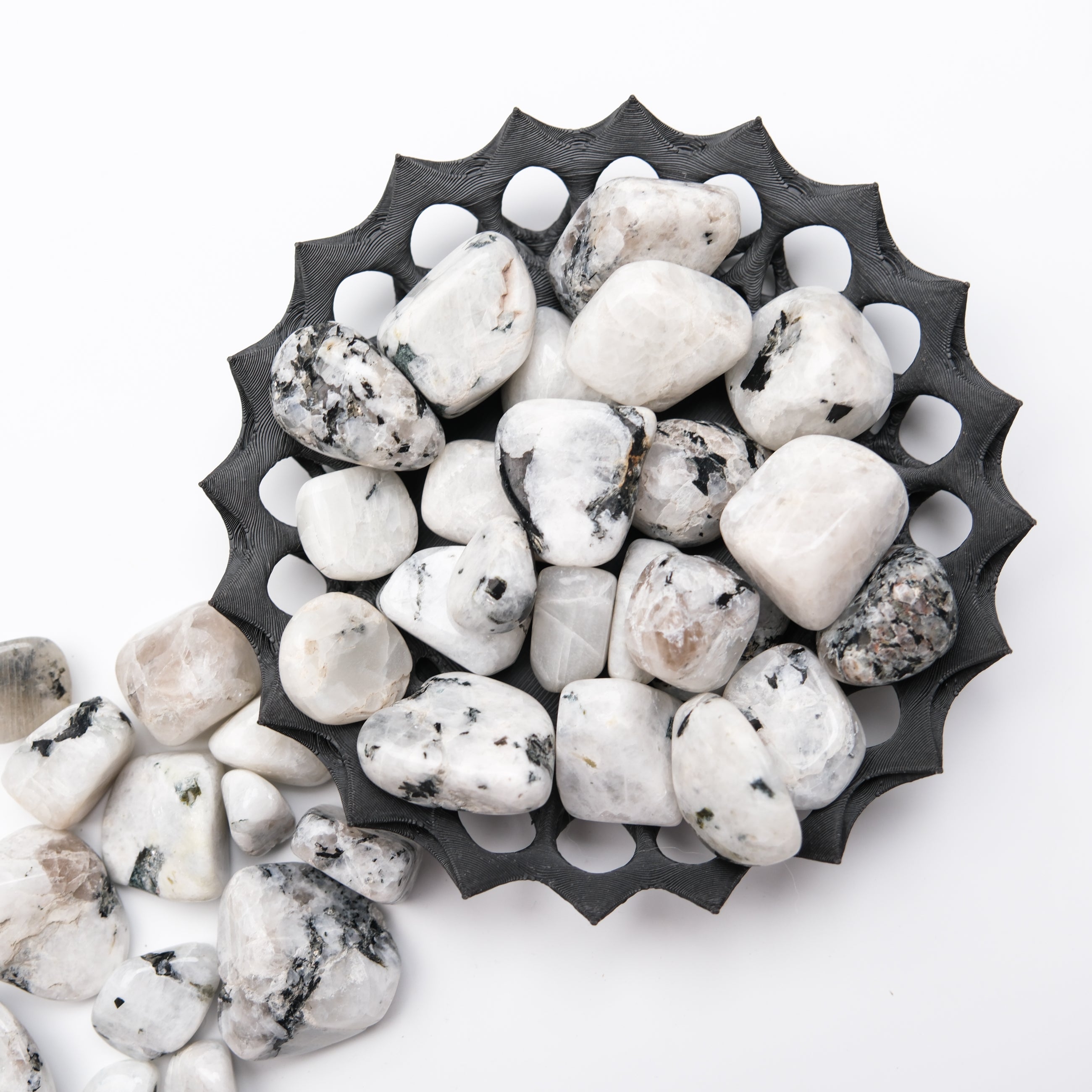 Noctis Studio moonstone tumble stone showing a smooth, polished round gemstone with iridescent blue and white flashes.