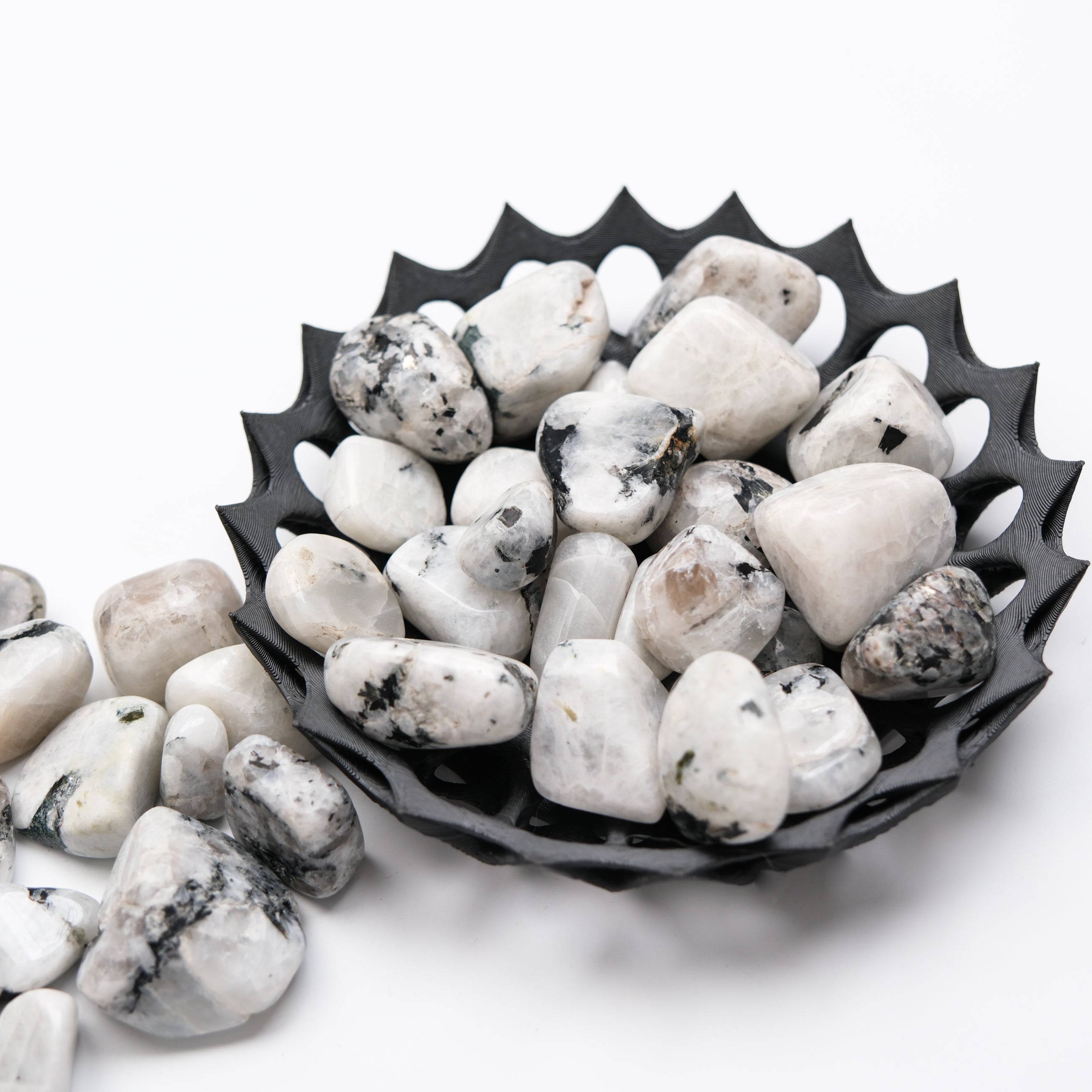 Smooth moonstone tumble stone from Noctis Studio showing its iridescent, milky surface and rounded shape.
