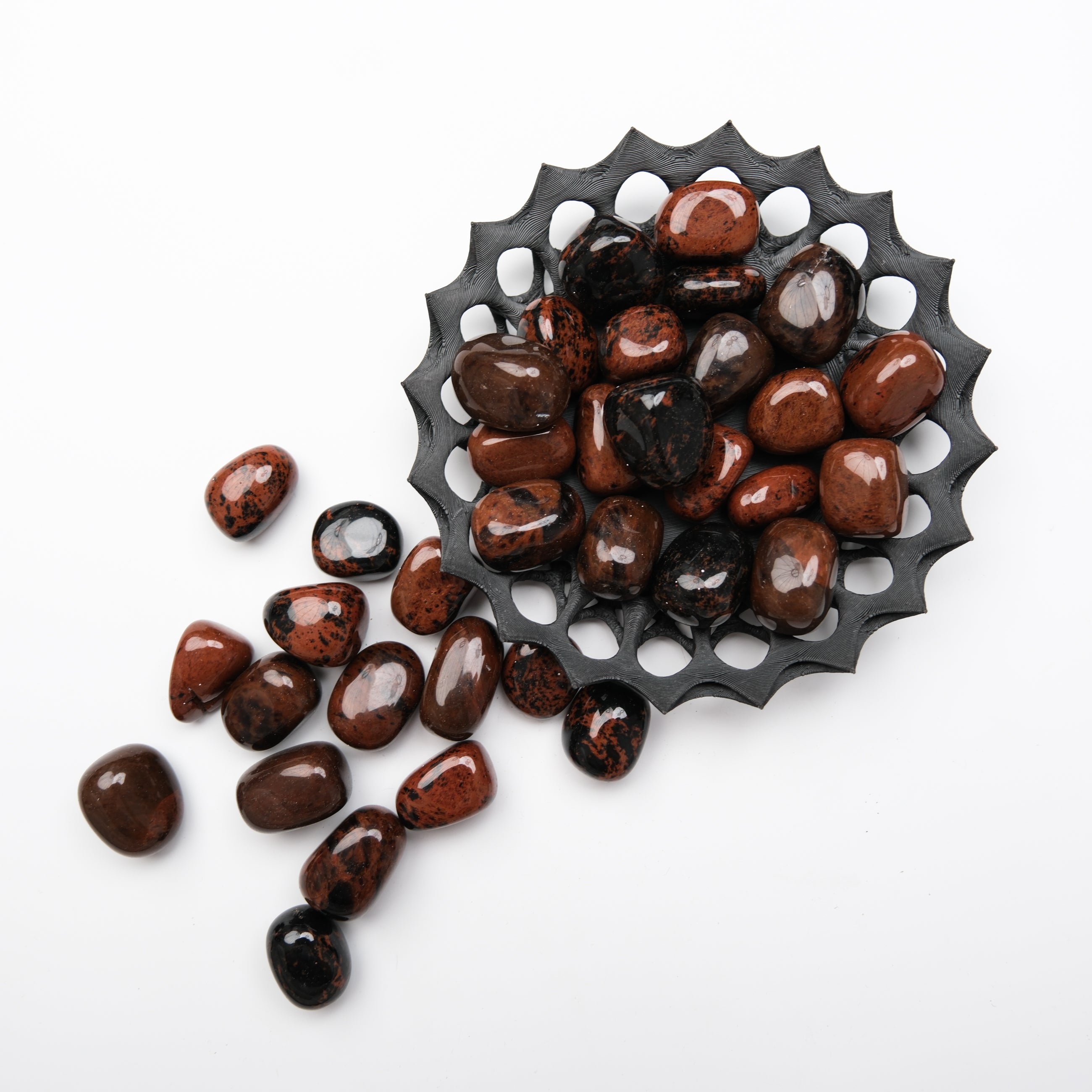 Mahogany Obsidian tumble stone from Noctis Studio, polished dark brown and red volcanic glass mineral with unique natural patterns.