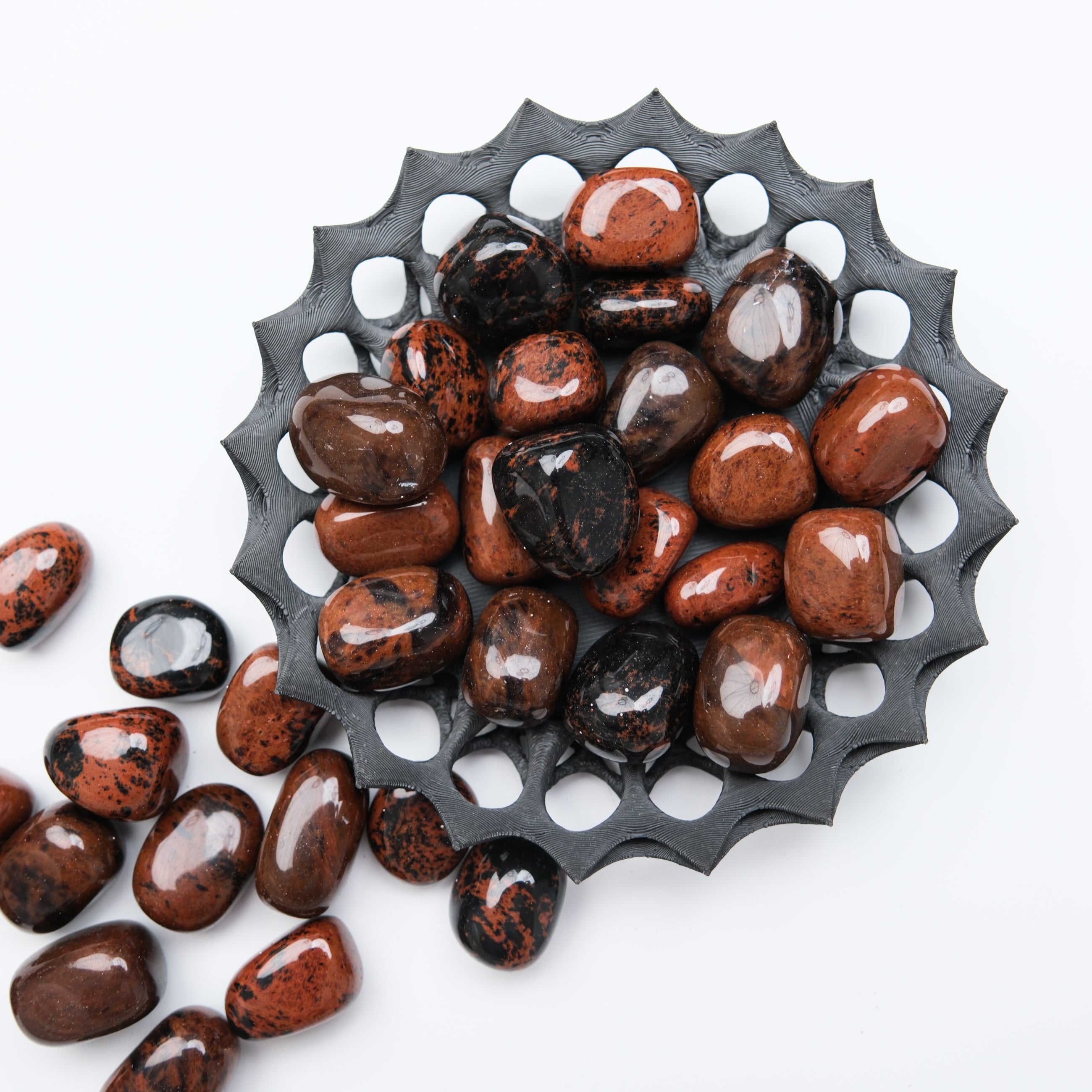 Mahogany Obsidian tumble stone from Noctis Studio with smooth, polished surface and rich reddish-brown and black coloration.