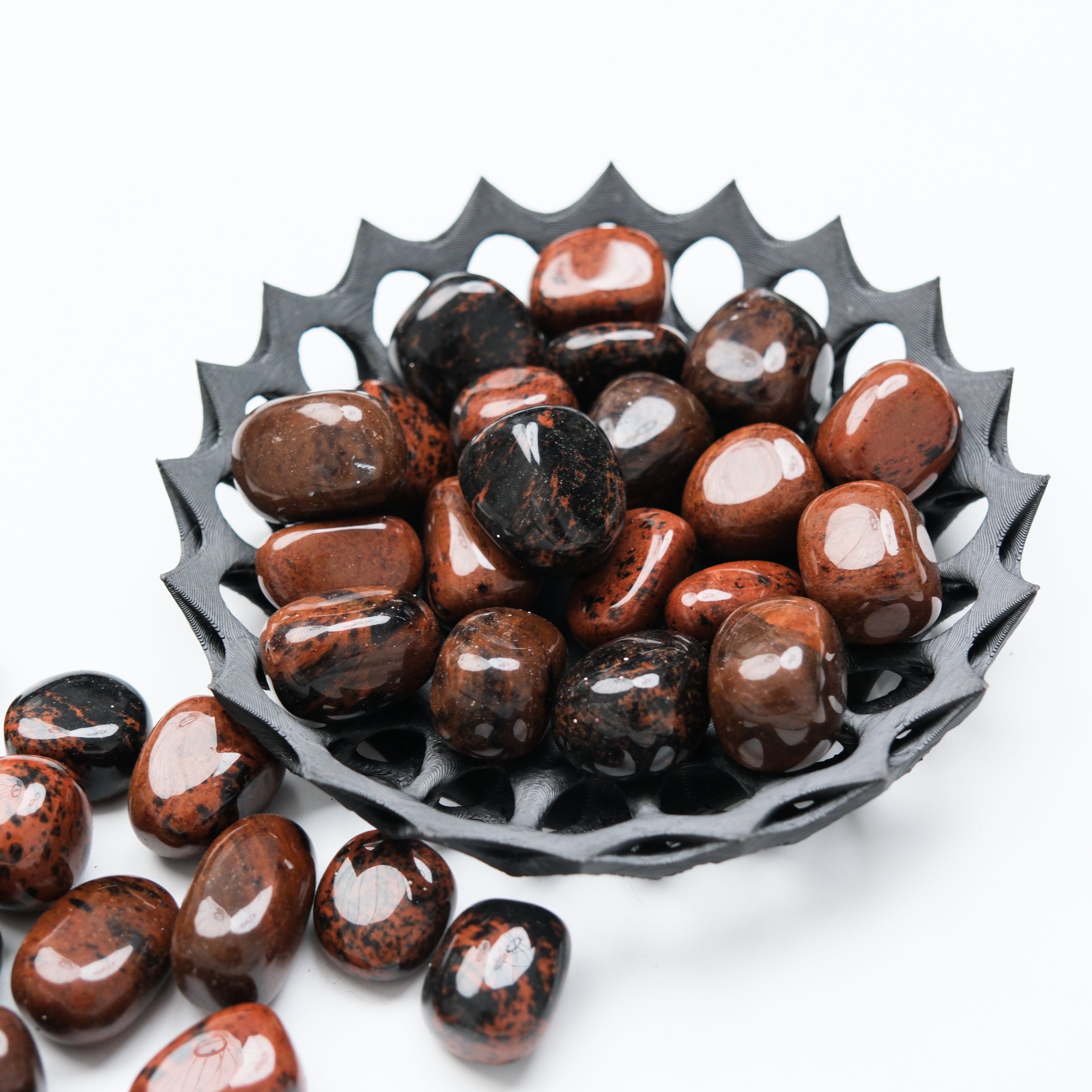 Mahogany Obsidian tumble stone from Noctis Studio showing smooth, polished dark red and black volcanic rock for healing and grounding.