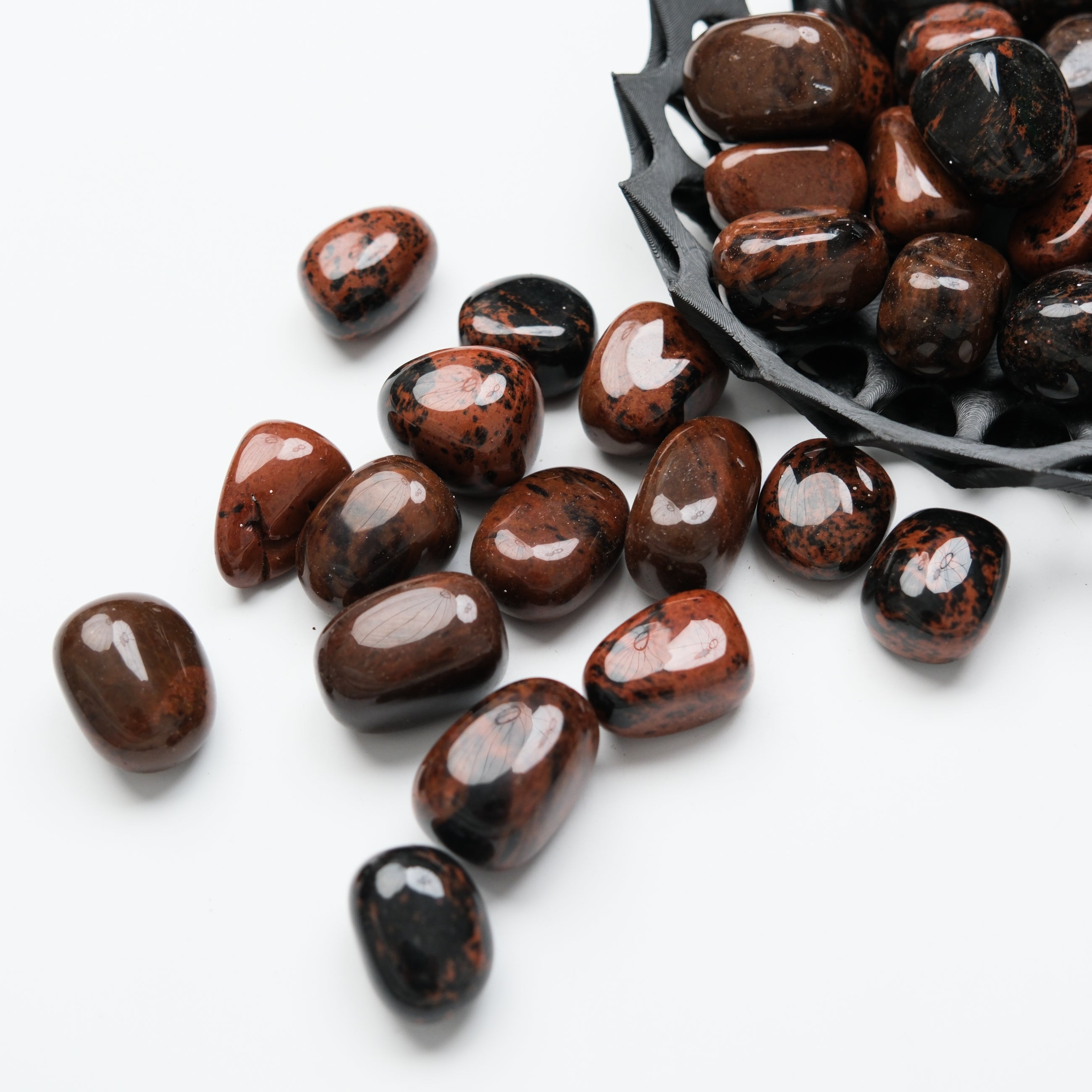 Mahogany Obsidian tumble stone from Noctis Studio, polished smooth with rich reddish-brown and black volcanic glass appearance.
