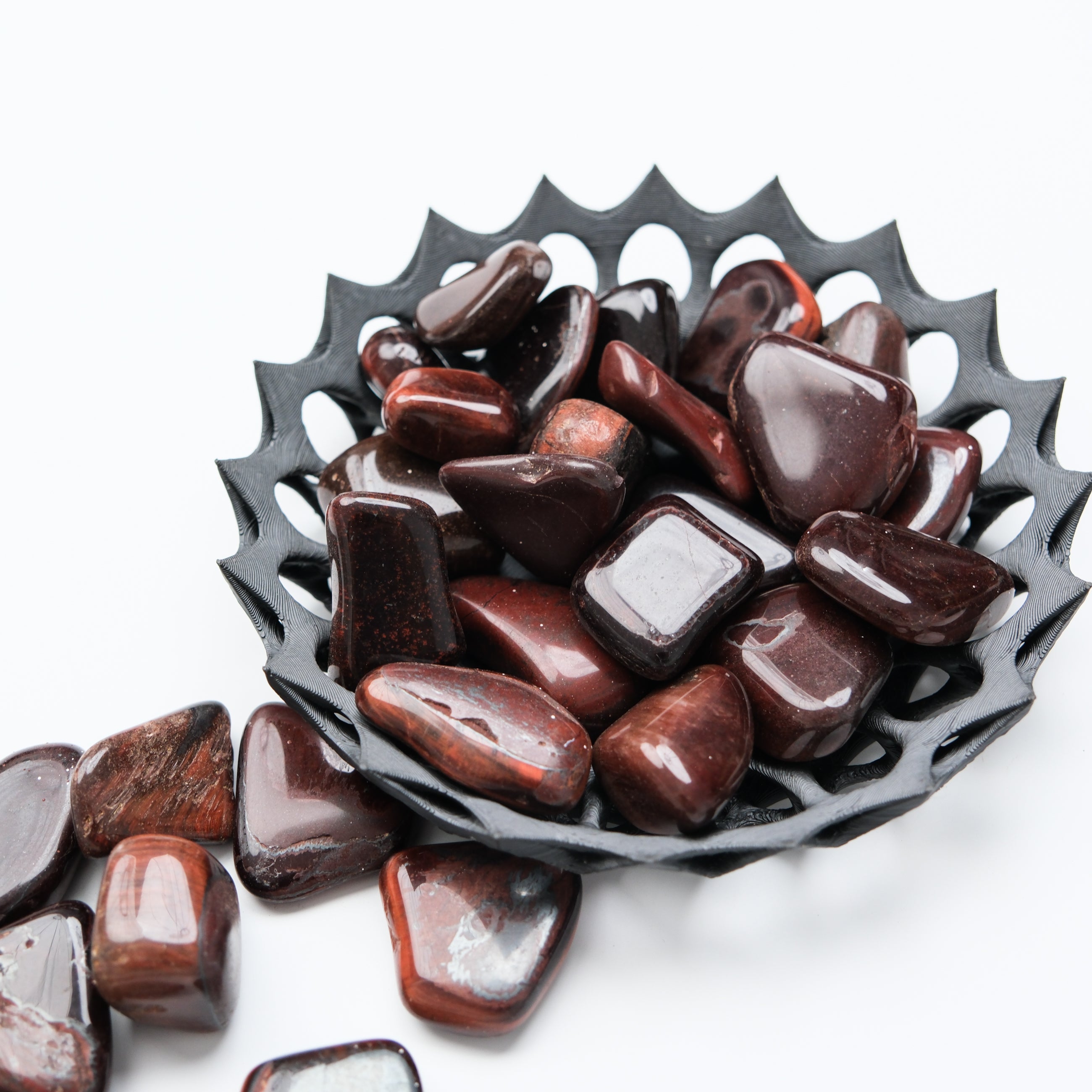 Red Tigers Eye tumble stone from Noctis Studio, showcasing smooth polished gemstone with rich red and gold hues.