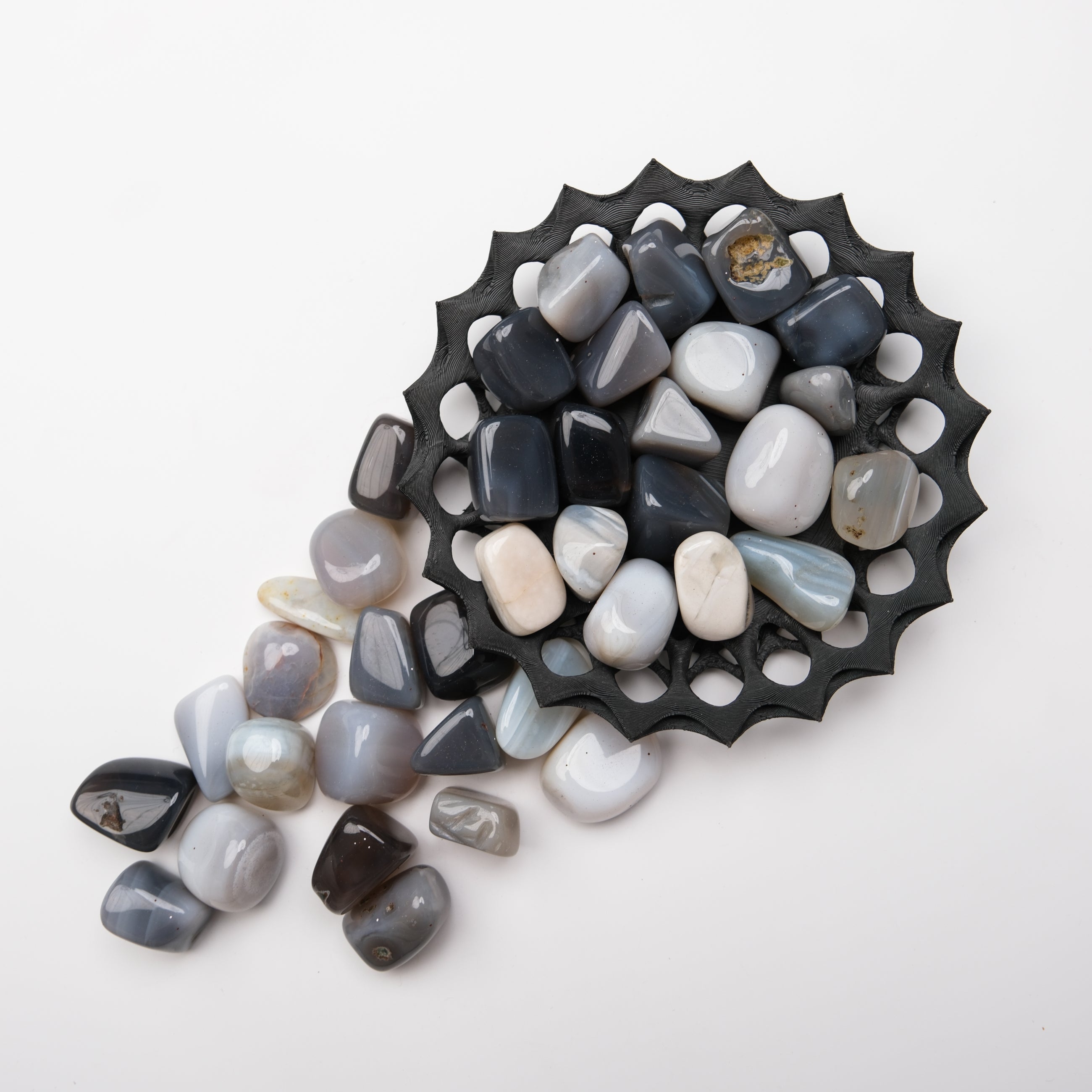 Grey agate tumble stone from Noctis Studio, polished mineral specimen with banded grey patterns, suitable for collection or meditation.