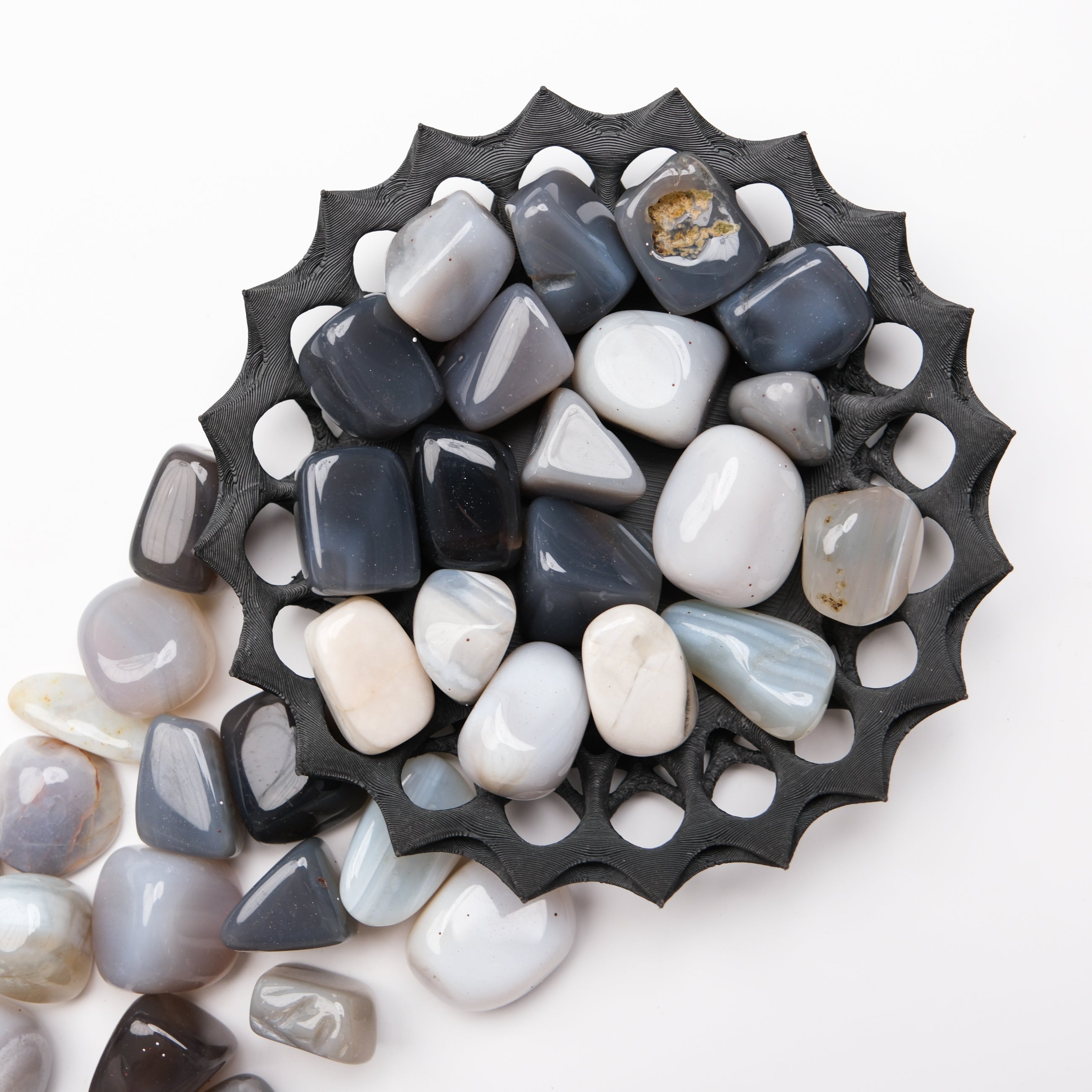Gray agate tumble stone from Noctis Studio, showcasing smooth, polished gemstone with natural banding and unique patterns.