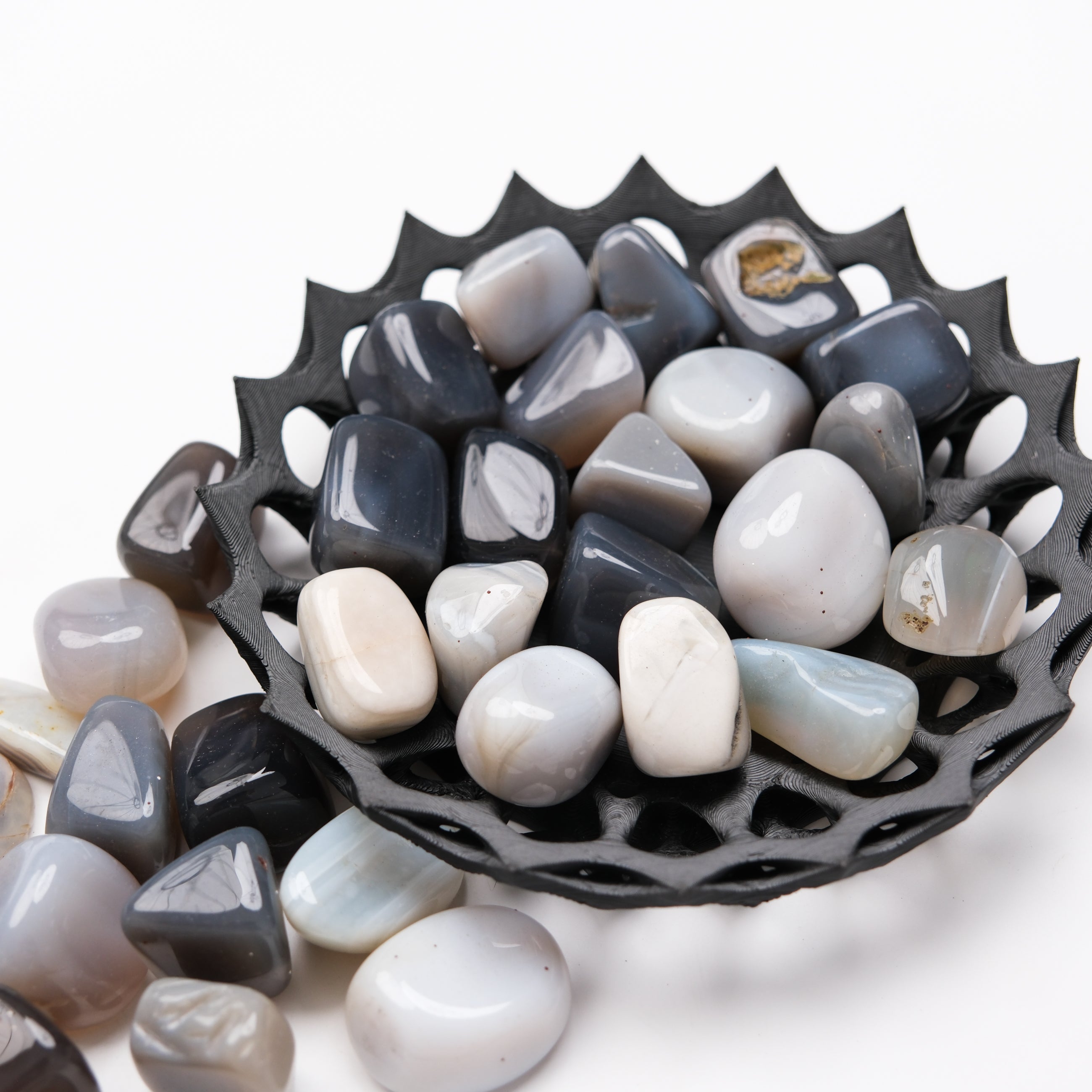 Grey Agate tumble stone from Noctis Studio, showing smooth, polished gemstone with natural grey banding and rounded shape.
