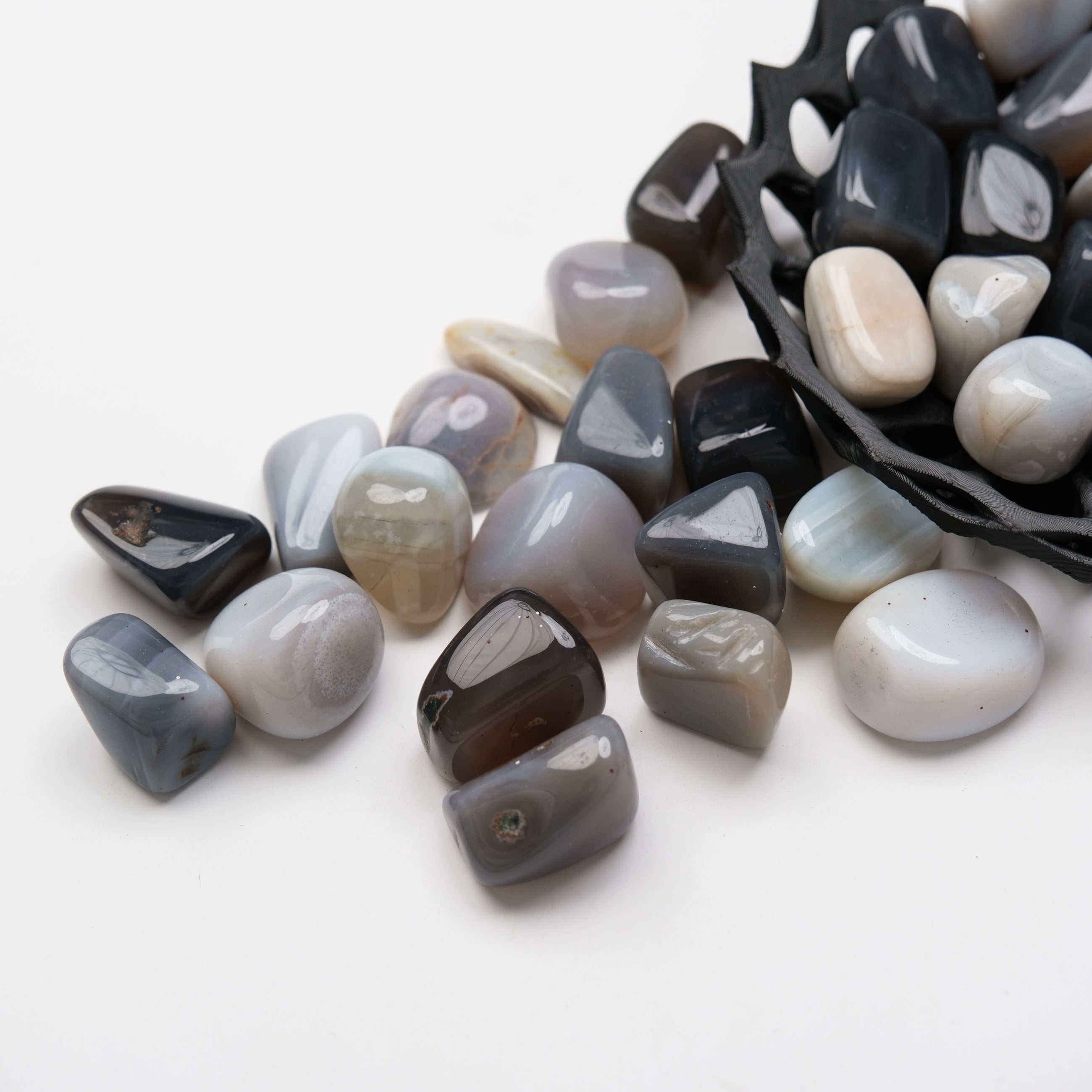 Grey Agate tumble stone from Noctis Studio, smooth polished gemstone with natural banding and rounded shape.