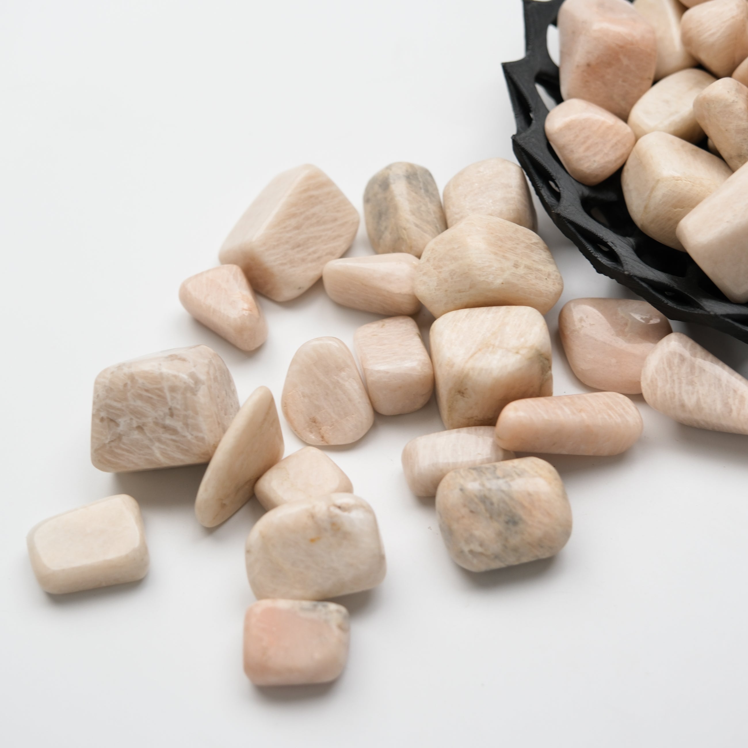 Cream moonstone tumble stone from Noctis Studio, showcasing smooth, rounded gemstone with soft, milky appearance and subtle shimmer.