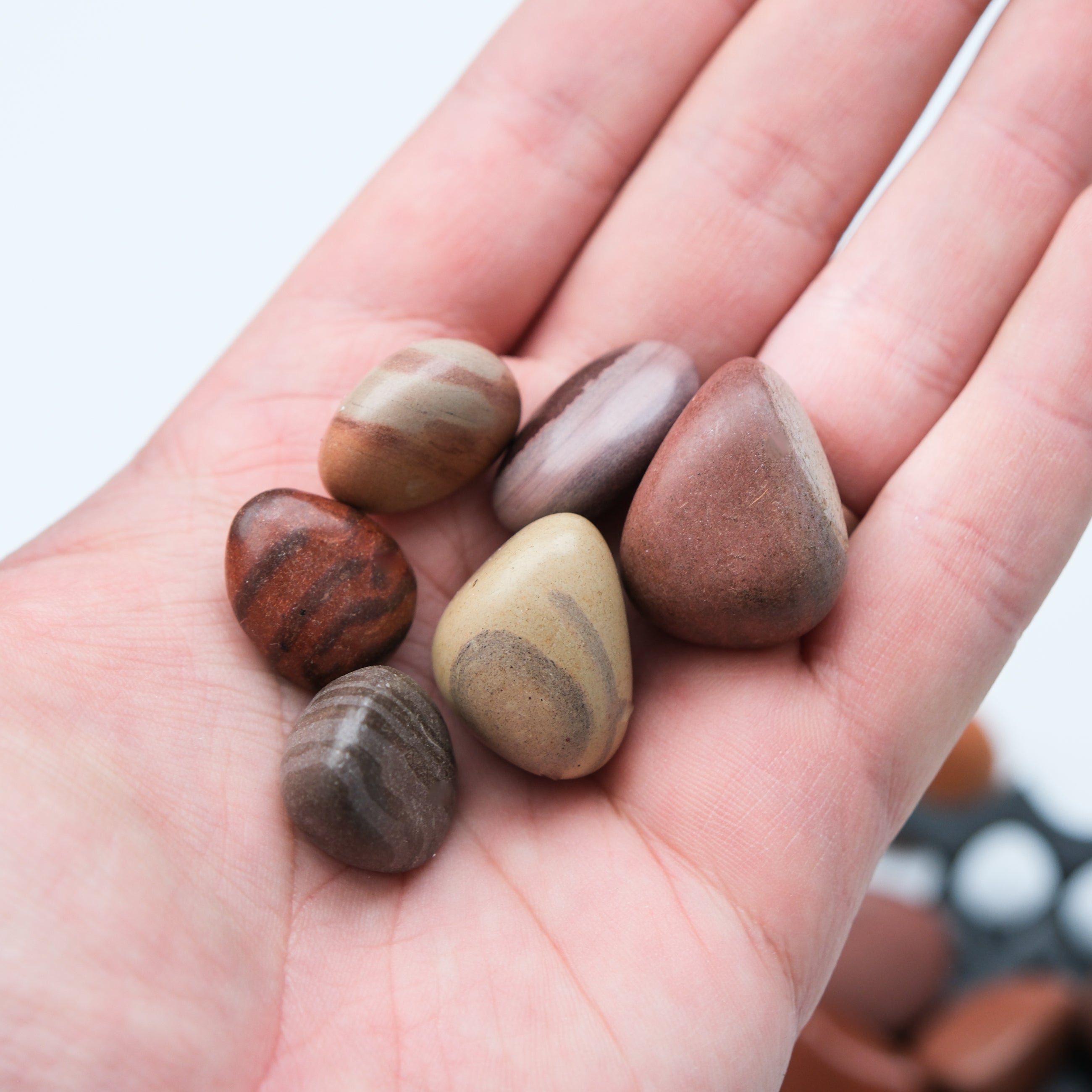Smooth gray Print Stone tumble stone from Noctis Studio, polished and rounded for decorative or healing purposes.