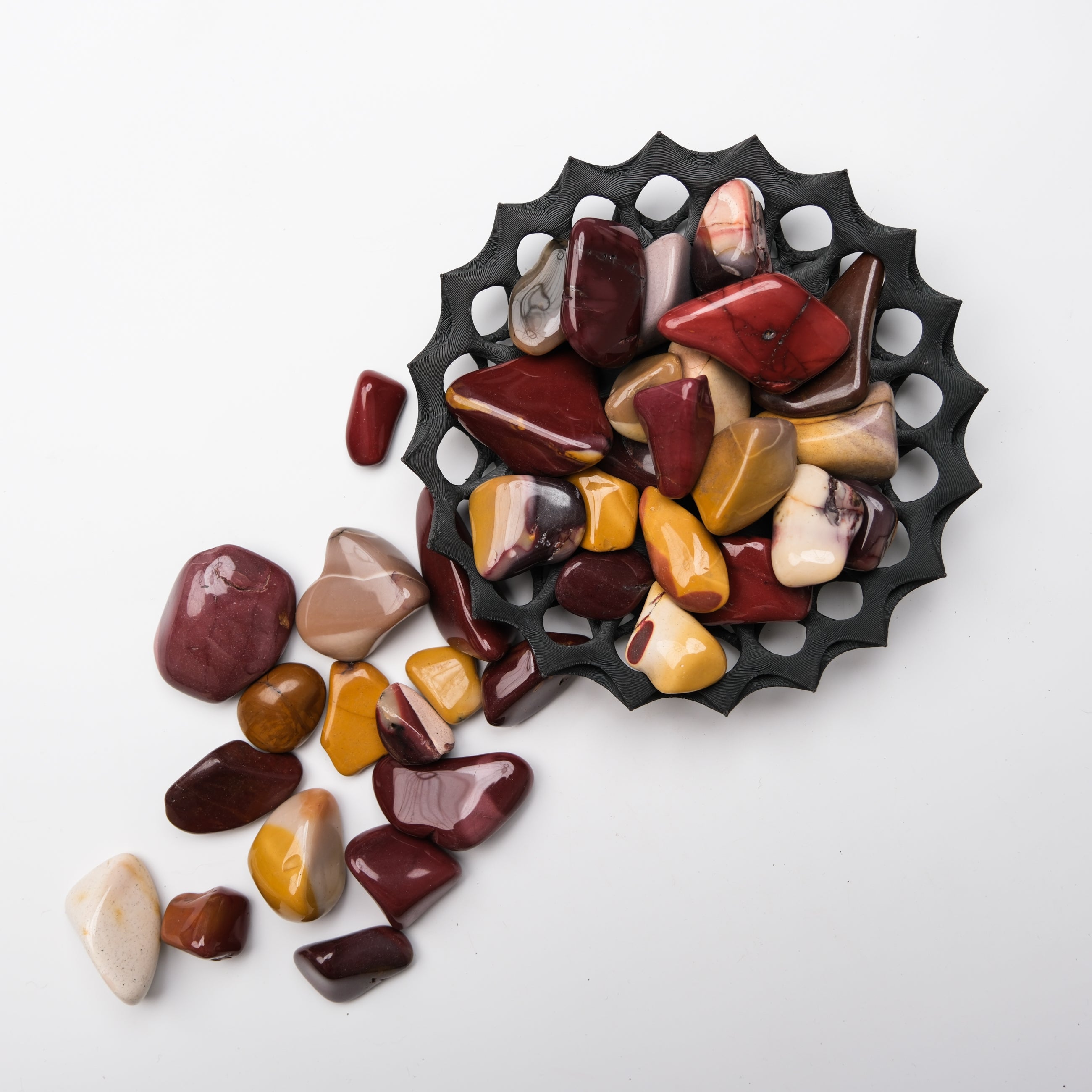 Noctis Studio Mookaite tumble stone, smooth polished mineral with earthy red and yellow tones, natural gemstone for collection or jewelry.