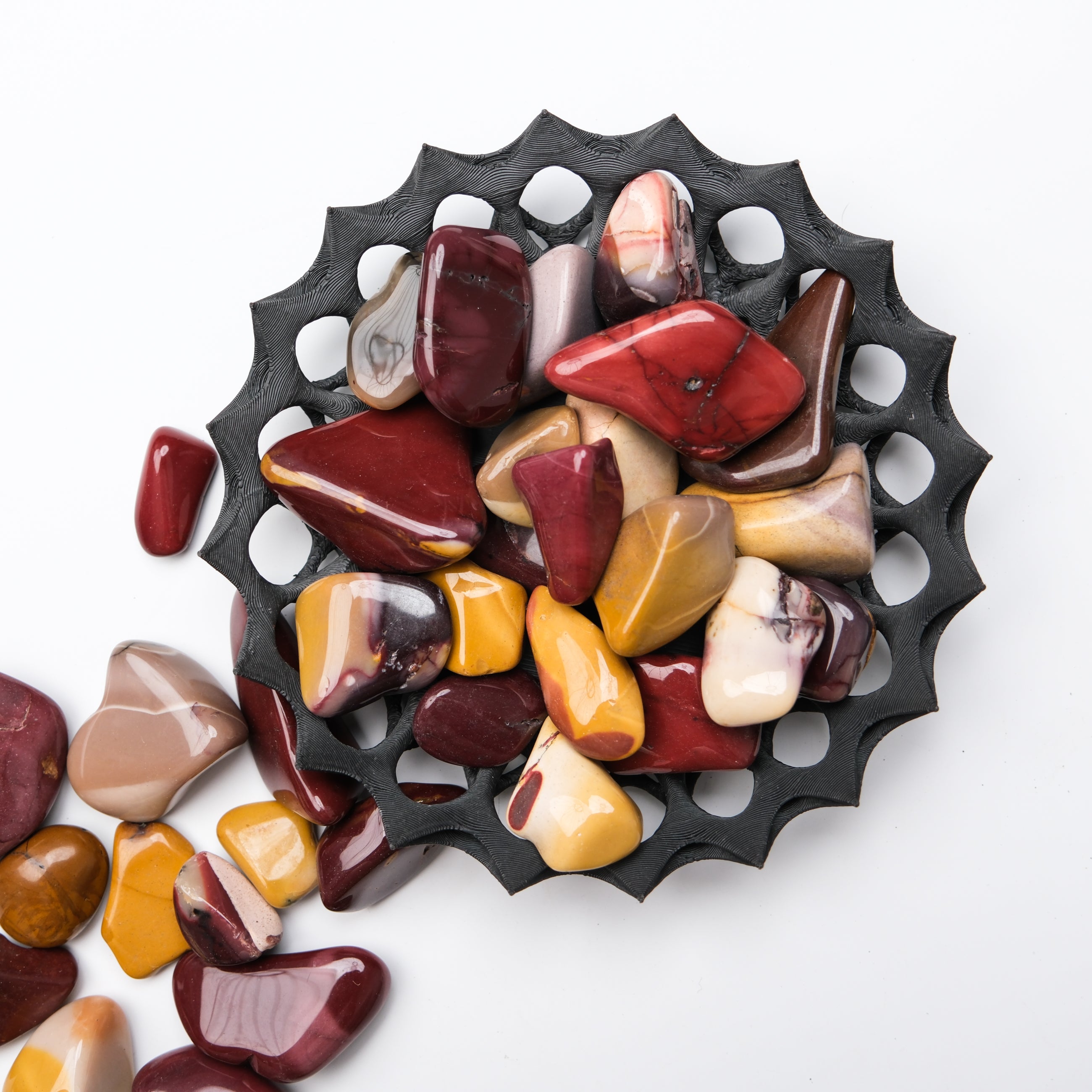 Mookaite tumble stone by Noctis Studio showing vibrant red, yellow, and cream natural jasper with polished smooth surface.
