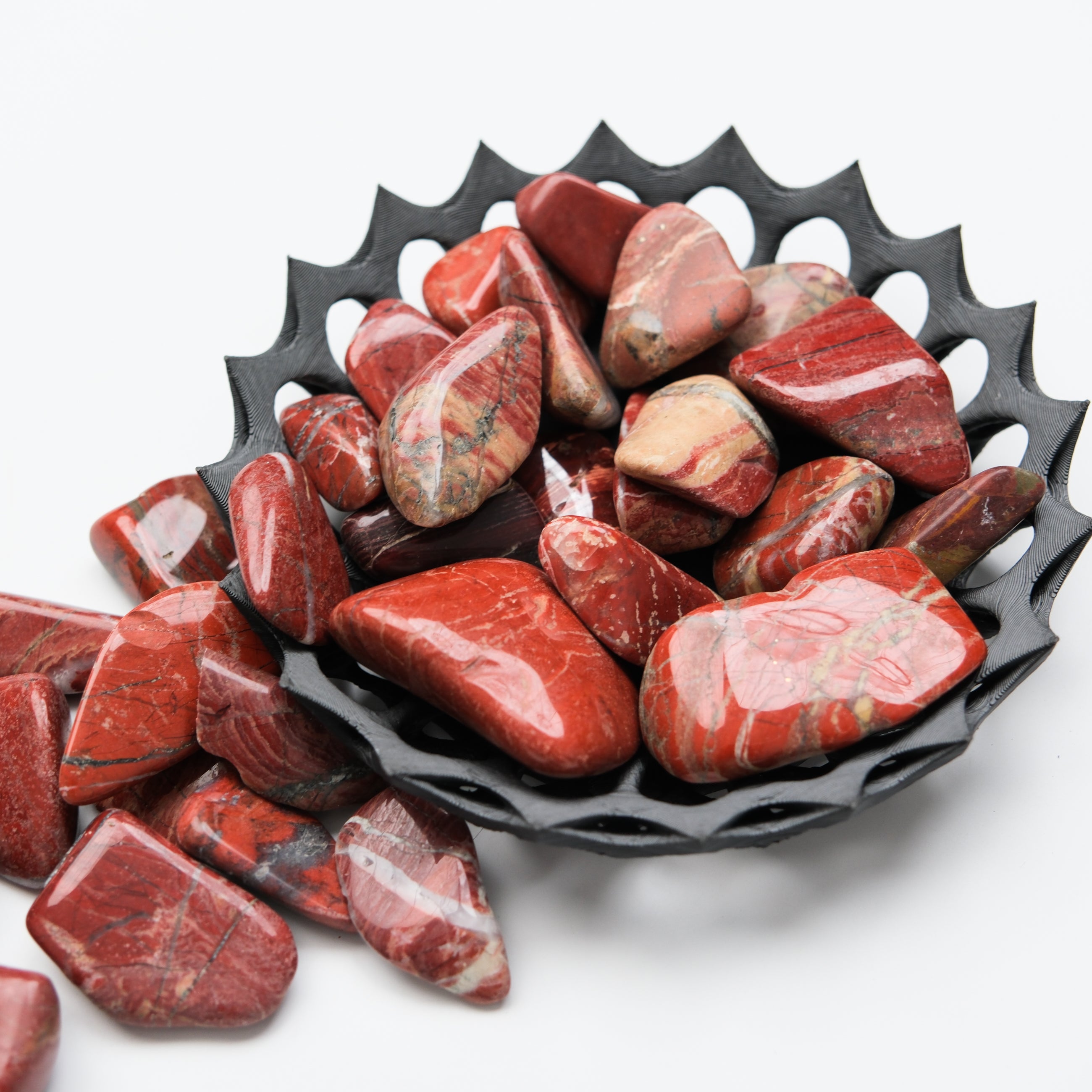 Red Jasper tumble stone from Noctis Studio, showing smooth, polished red gemstone with natural patterns and vibrant color.