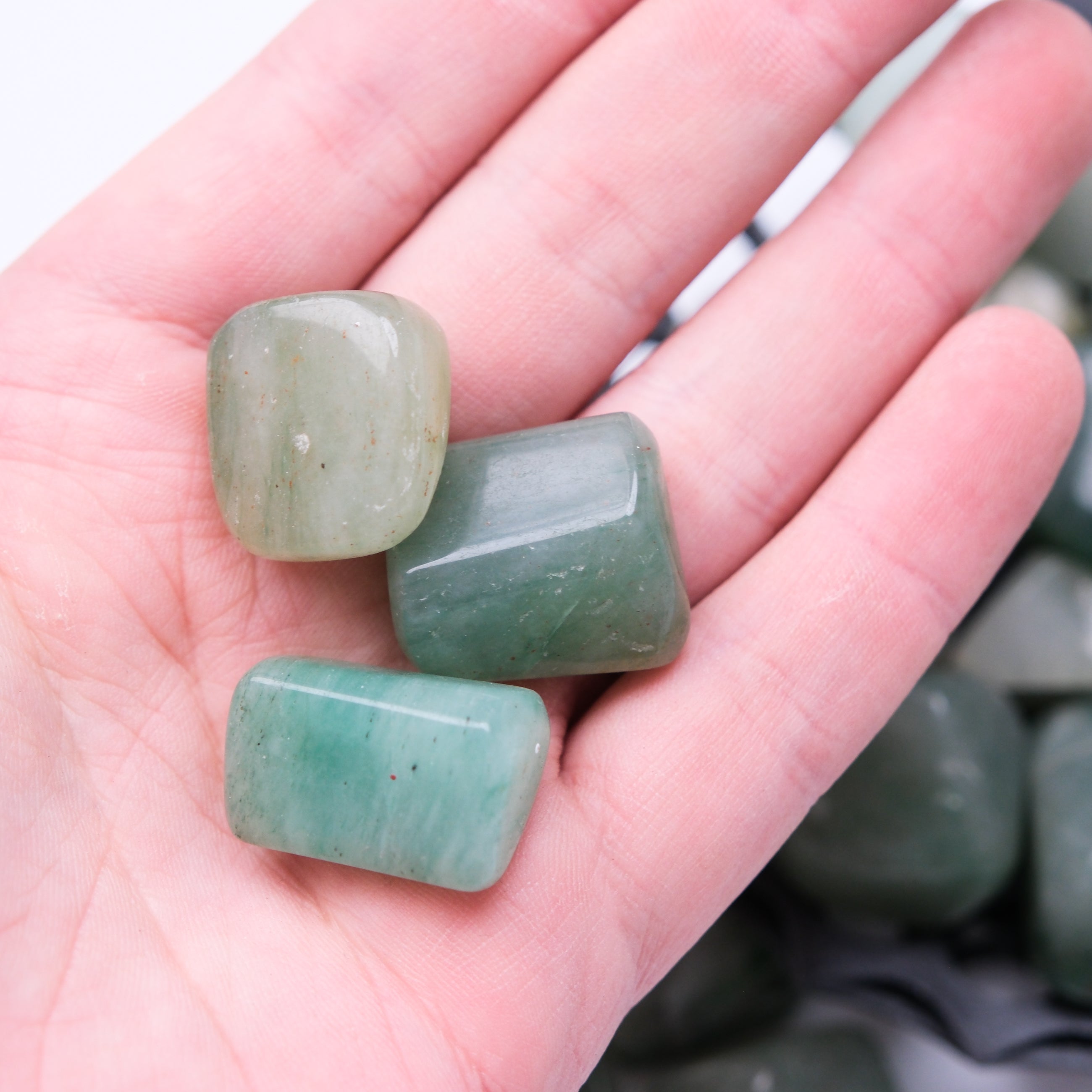 Green Aventurine tumble stone from Noctis Studio, polished gemstone with vibrant green color and natural stone pattern.