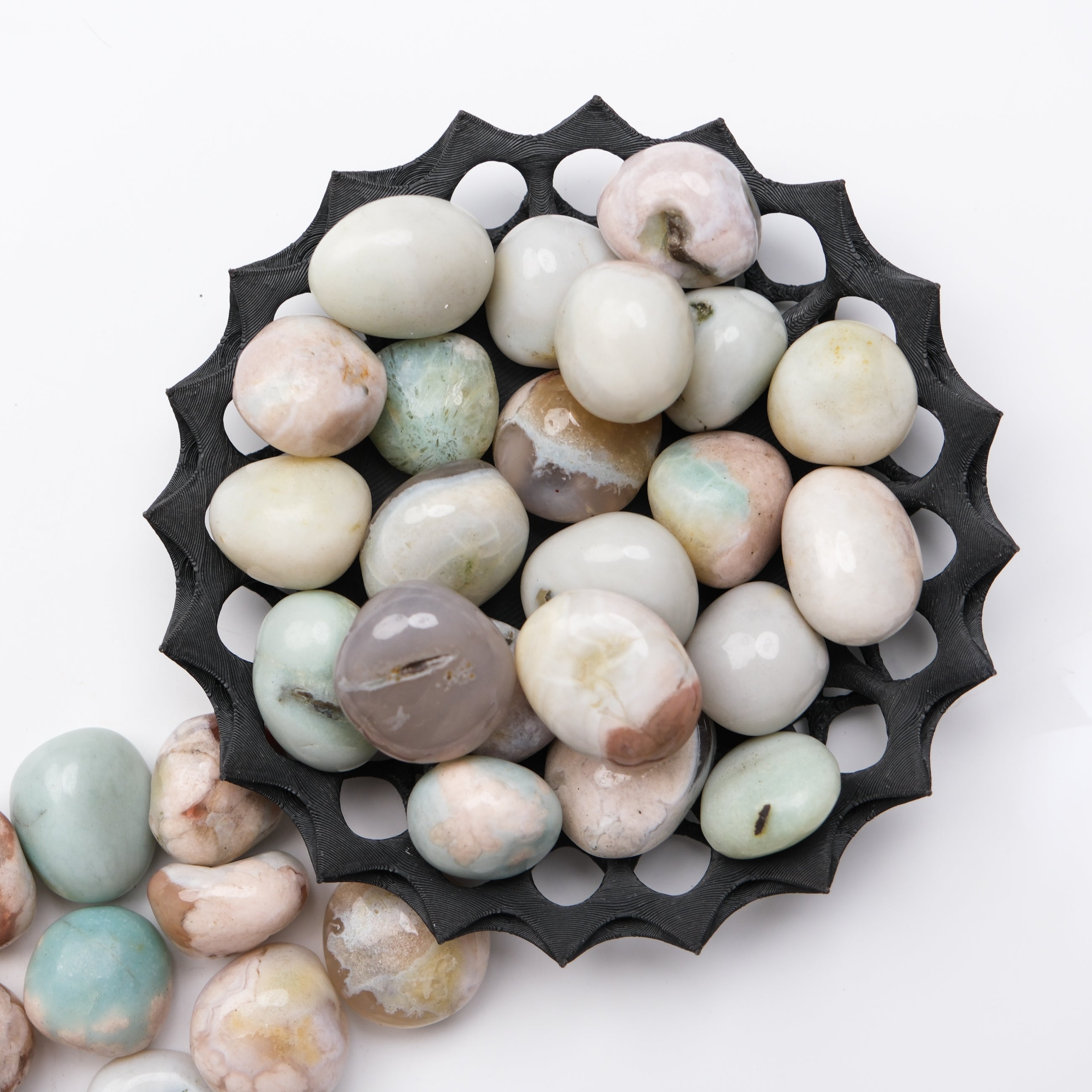 Green Flower Agate tumble stone by Noctis Studio, showcasing polished, vibrant green and floral patterns on a smooth stone.