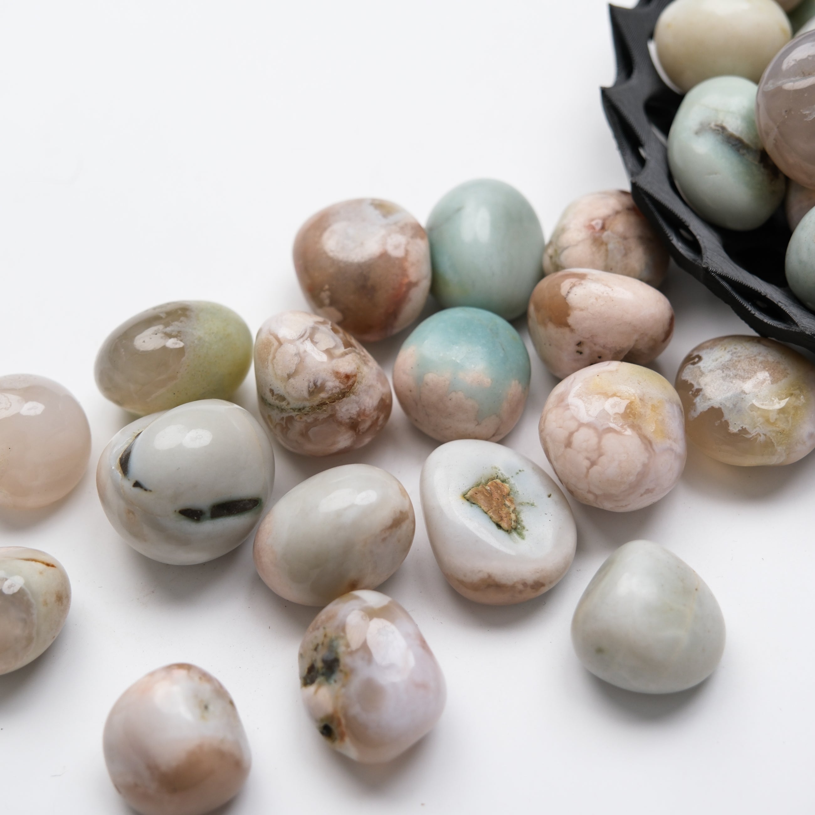 Green Flower Agate tumble stone from Noctis Studio, showcasing a polished, vibrant green and floral pattern on a smooth stone surface.