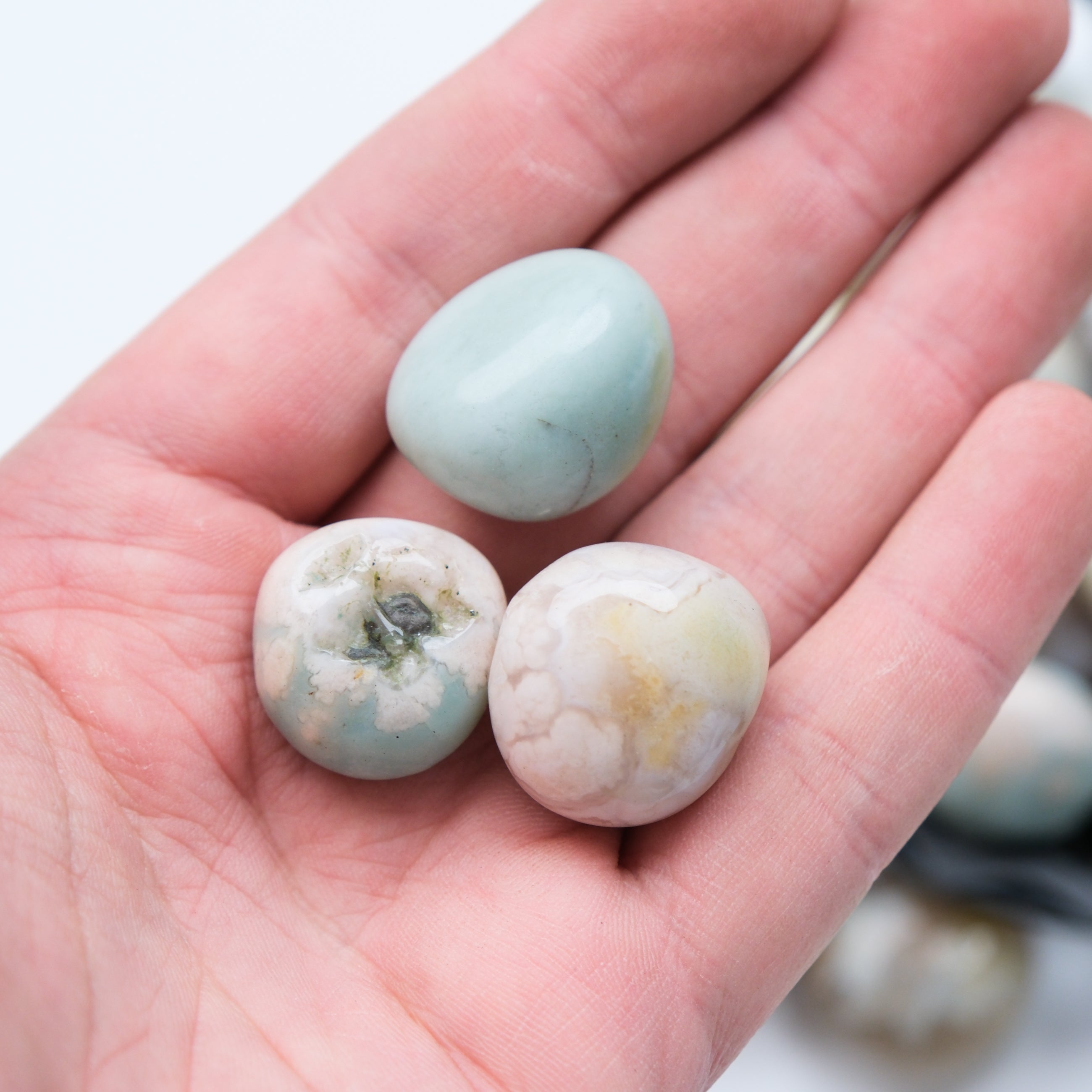 Green Flower Agate tumble stone from Noctis Studio, smooth polished gemstone with vibrant green and floral patterns.