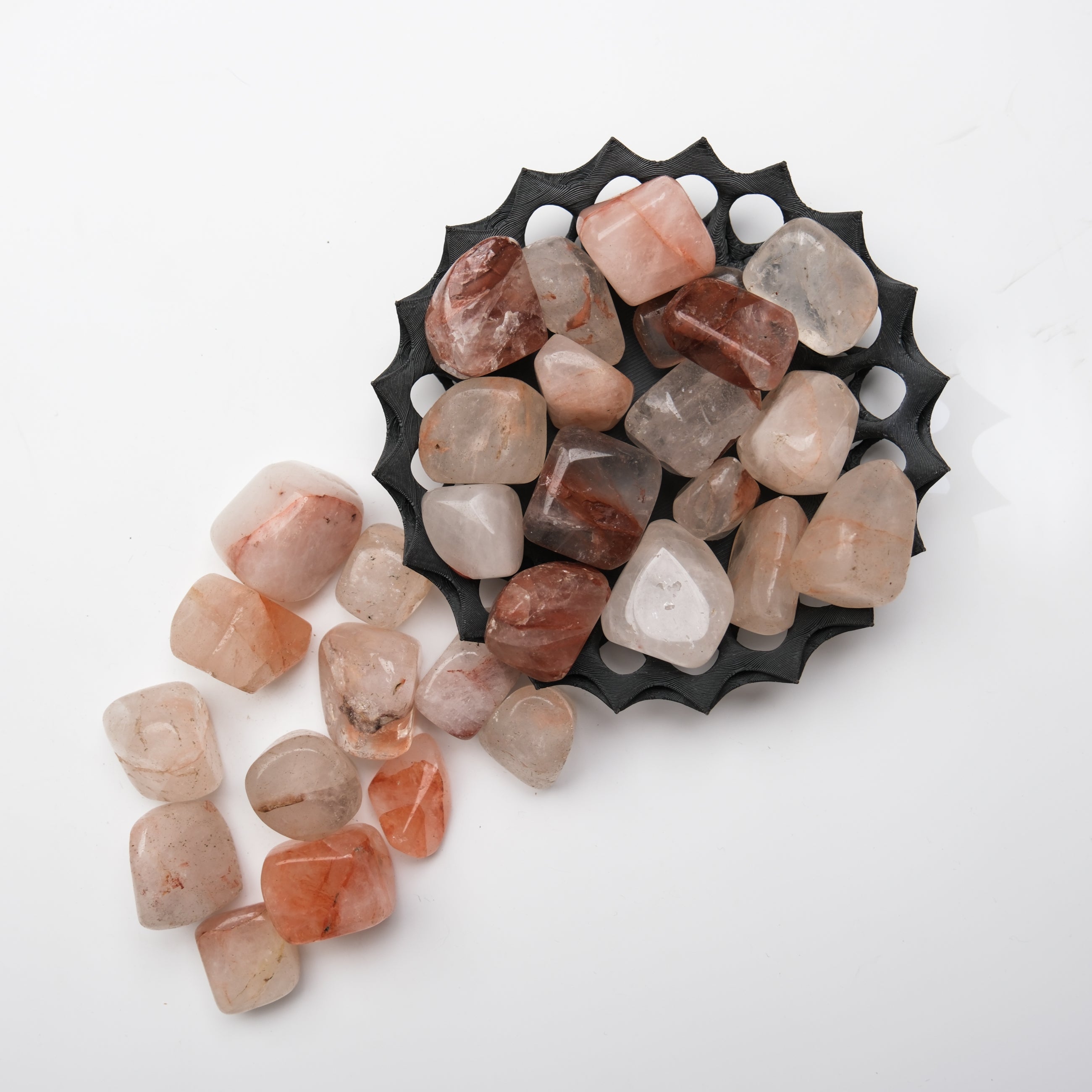 Hematoid Quartz tumble stone from Noctis Studio, smooth polished gemstone with red and clear mineral patterns.